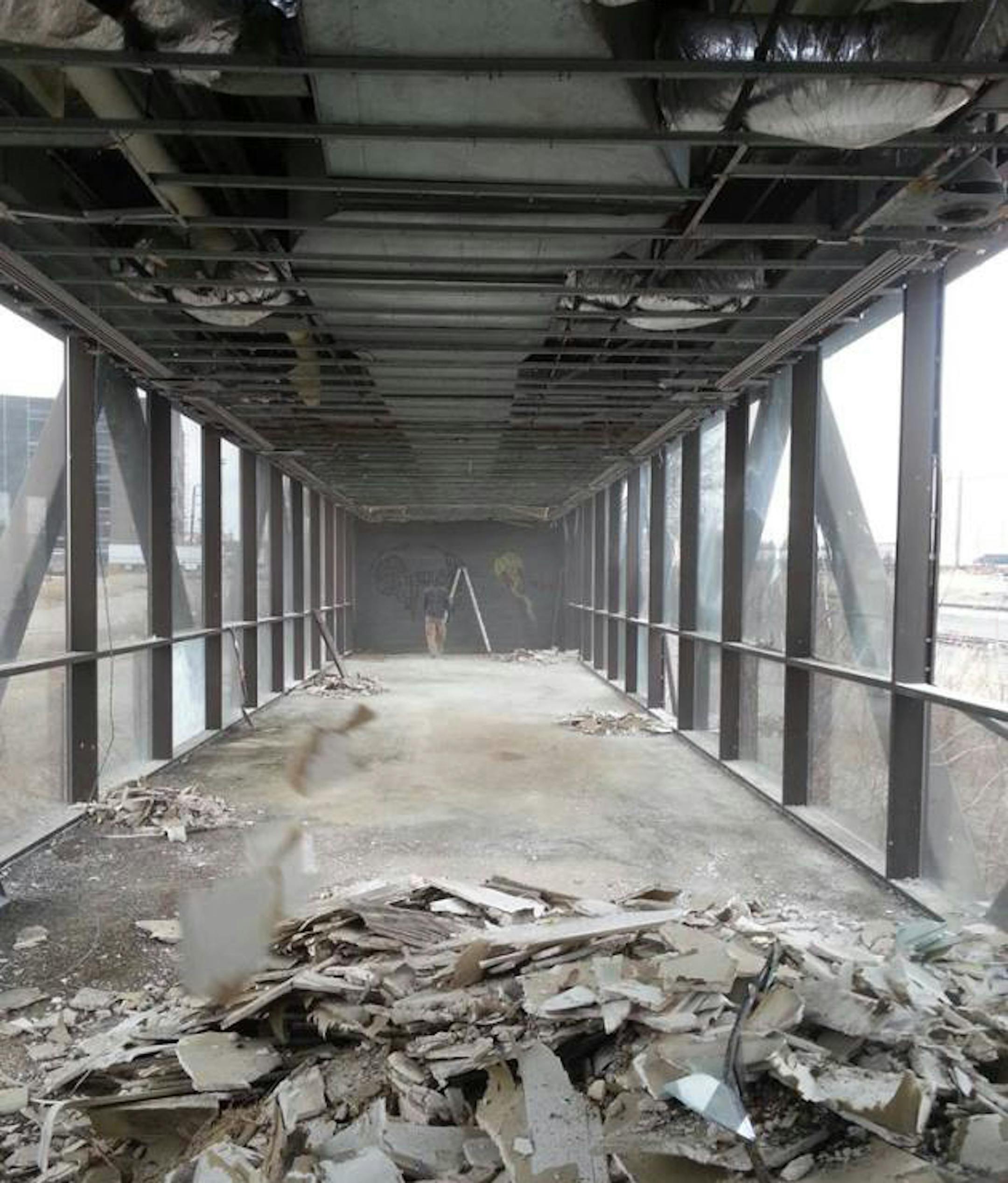 To prepare the skyway for the installation and move, crews are busy removing an old concrete floor and ductwork. ORG XMIT: 0QkFyUIKUBxEtmJMZ53Y