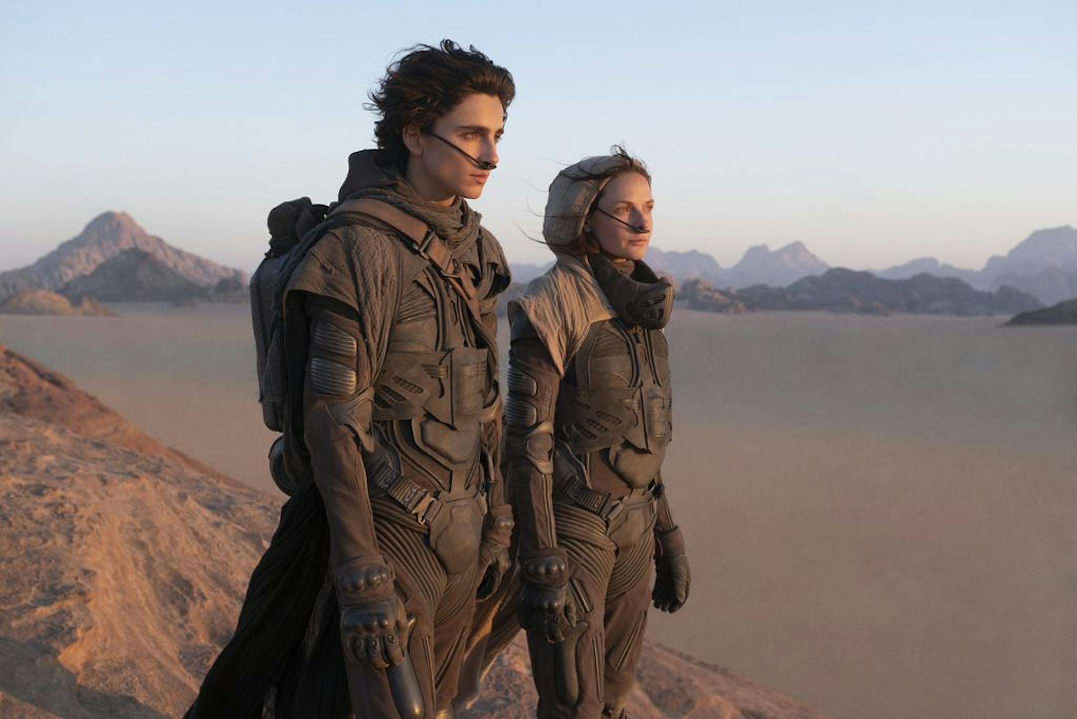 This image released by Warner Bros. Entertainment shows Timothee Chalamet, left, and Rebecca Ferguson in a scene from the upcoming 2021 film "Dune." Warner Bos. Pictures on Thursday announced that all of its 2021 film slate will stream on HBO Max at the same time they play in theaters.