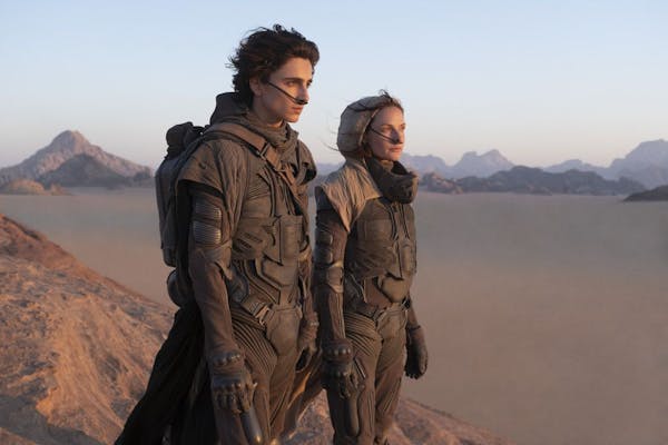 This image released by Warner Bros. Entertainment shows Timothee Chalamet, left, and Rebecca Ferguson in a scene from the upcoming 2021 film "Dune." W