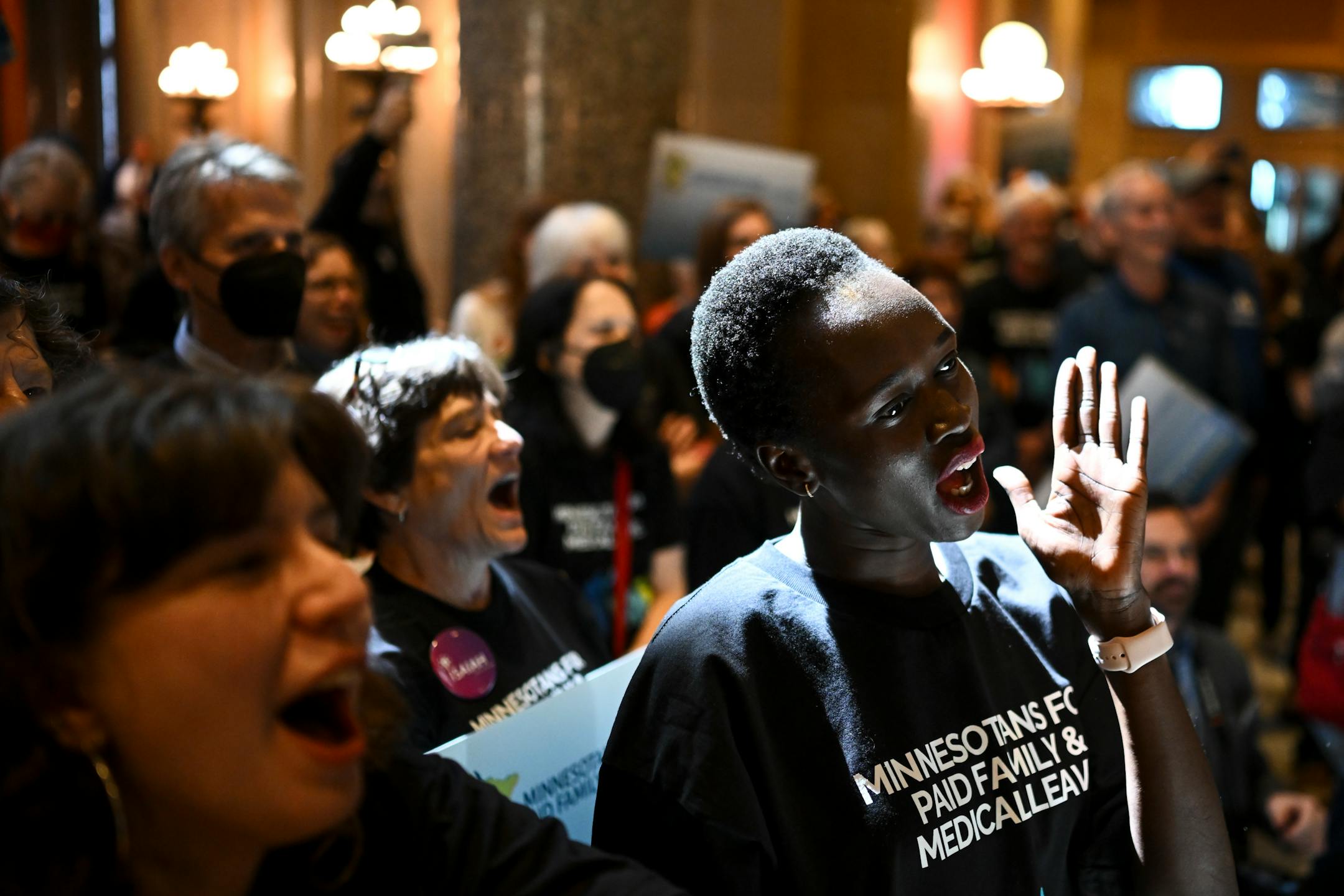 Nyabang Diang, with Newpublica, takes part in a paid family leave rally Monday at the Minnesota State Capitol.