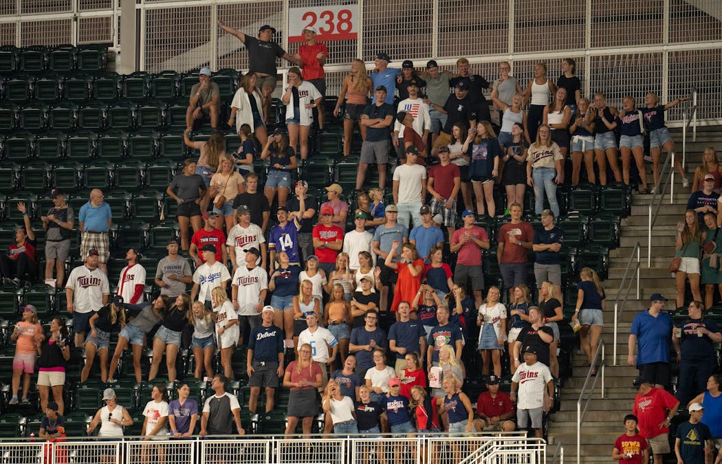 Twins fans stood and sang “Take Me Out to The Ball Game” during the seventh-inning stretch of a game against Detroit.