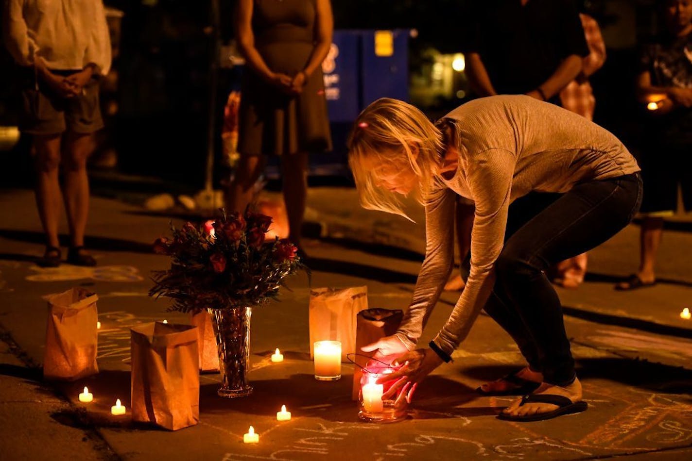 Mindy Barry, a neighbor and friend of Don Damond, placed a candle at a memorial set up at the site where Justine Damond Ruszczyk was killed by Minneapolis Police officer Mohamed Noor one year ago tonight.