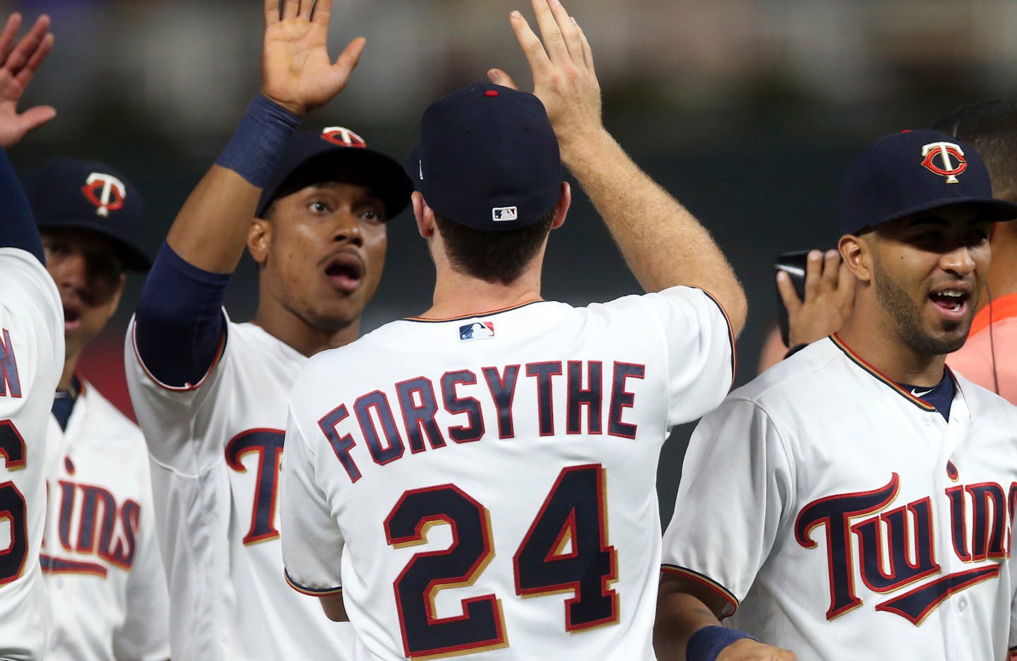 Jorge Polanco, left, congratulated Logan Forsythe, who had five hits in the Twins' 15-8 crushing of the Tigers at Target Field on Thursday night.