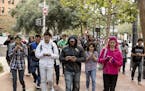 People walk up Market Street playing Pokemon Go, an augmented reality game, during a Pokemon Go Pub Crawl in San Francisco, July 20, 2016. Pokemon Go 