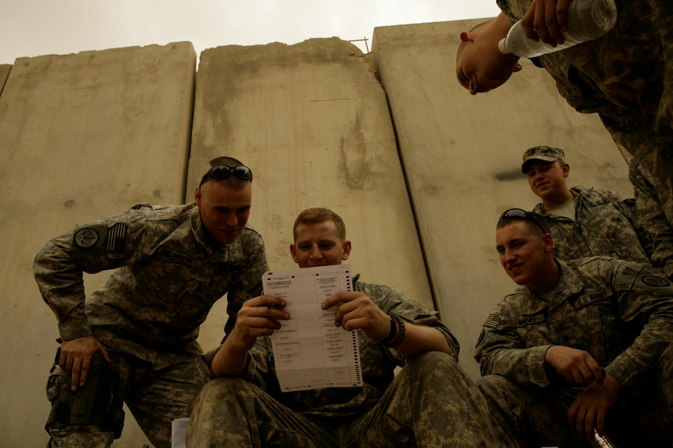 U.S. Army Cpl. Sean Morton, 25, from Boston, Mass., left, and a comrade assigned to Killer Troop, 3rd Squadron, 3rd Armored Cavalry Regiment, consult as they cast their votes for president at Forward Operating Base Marez in Mosul, Iraq on Wednesday.