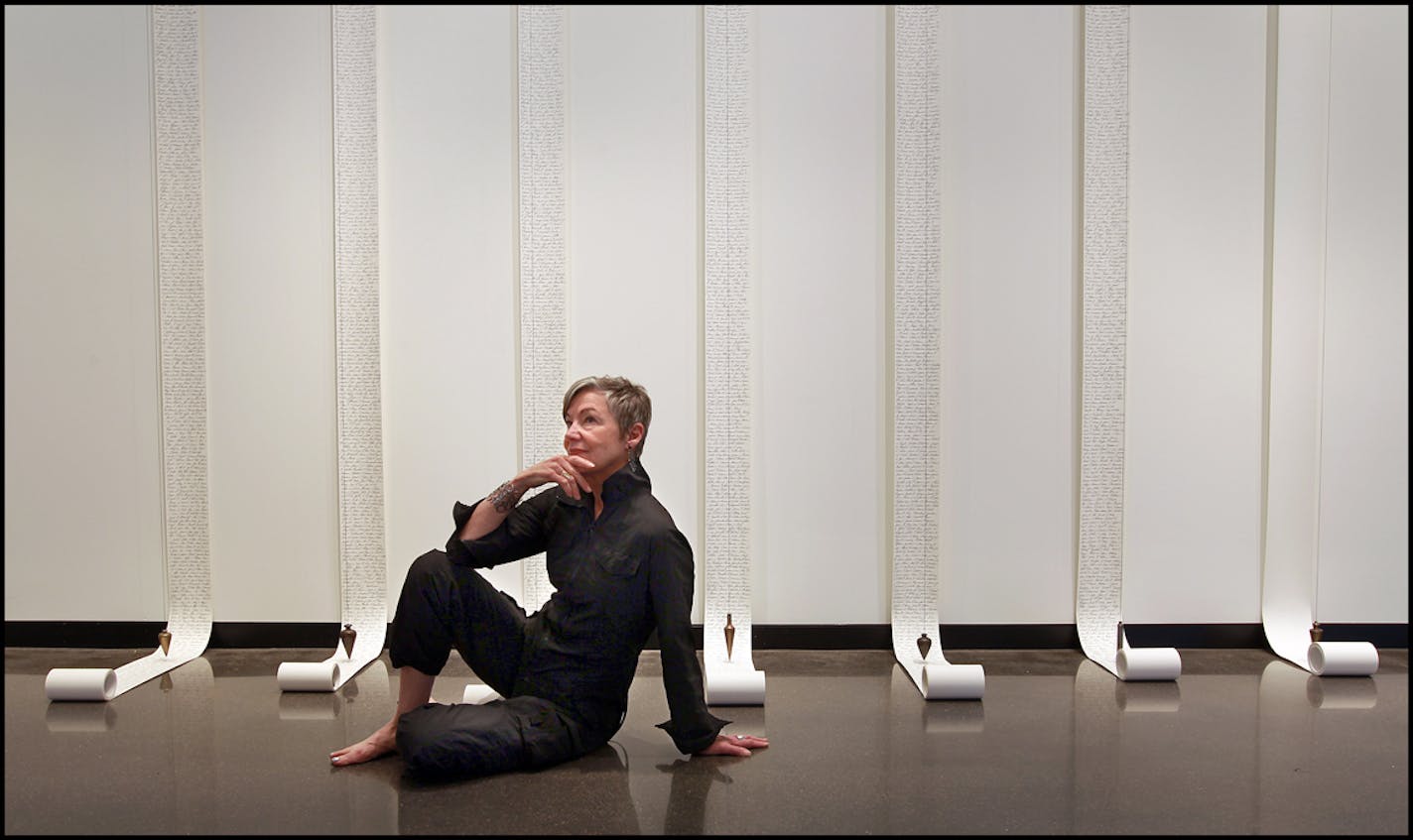 Harriet Bart, in front of "Requiem," on which the artist inscribed the names of 4,000 U.S. soldiers killed in the Iraq war. A show of Bart's work inaugurates the art center's new gallery space.