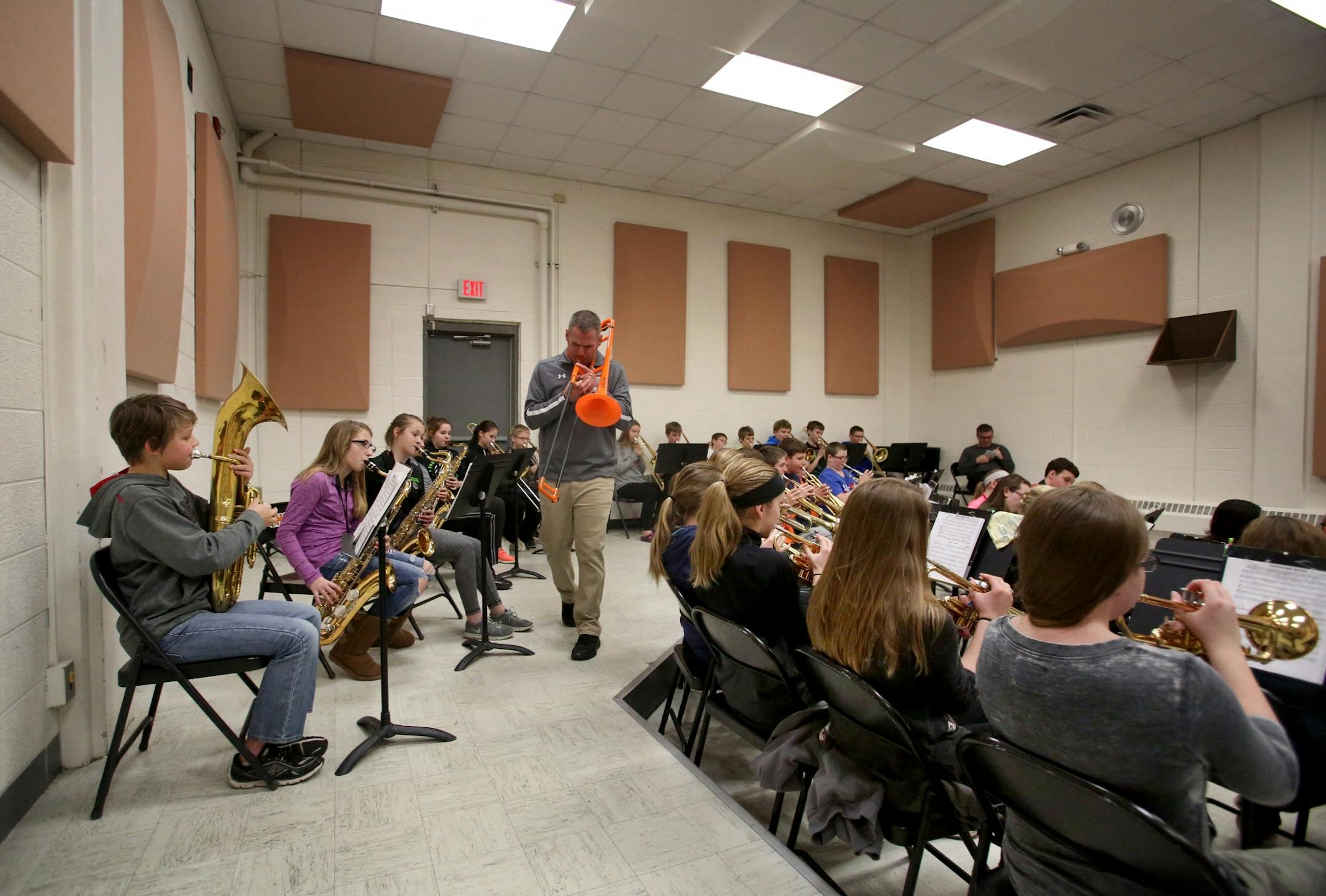 Erik Hermanson, band teacher and football coach at Cleveland Public School, leads 7th and 8th grade band members in practice during lunch Tuesday, Feb. 21, 2017, in Cleveland, MN. Hermanson uses a cheap plastic trombone, leaving better instruments for his students.