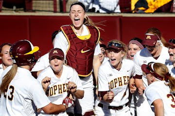 Gophers catcher Kendyl Lindaman (23) was greeted by teammates after hitting a three run home run last April.