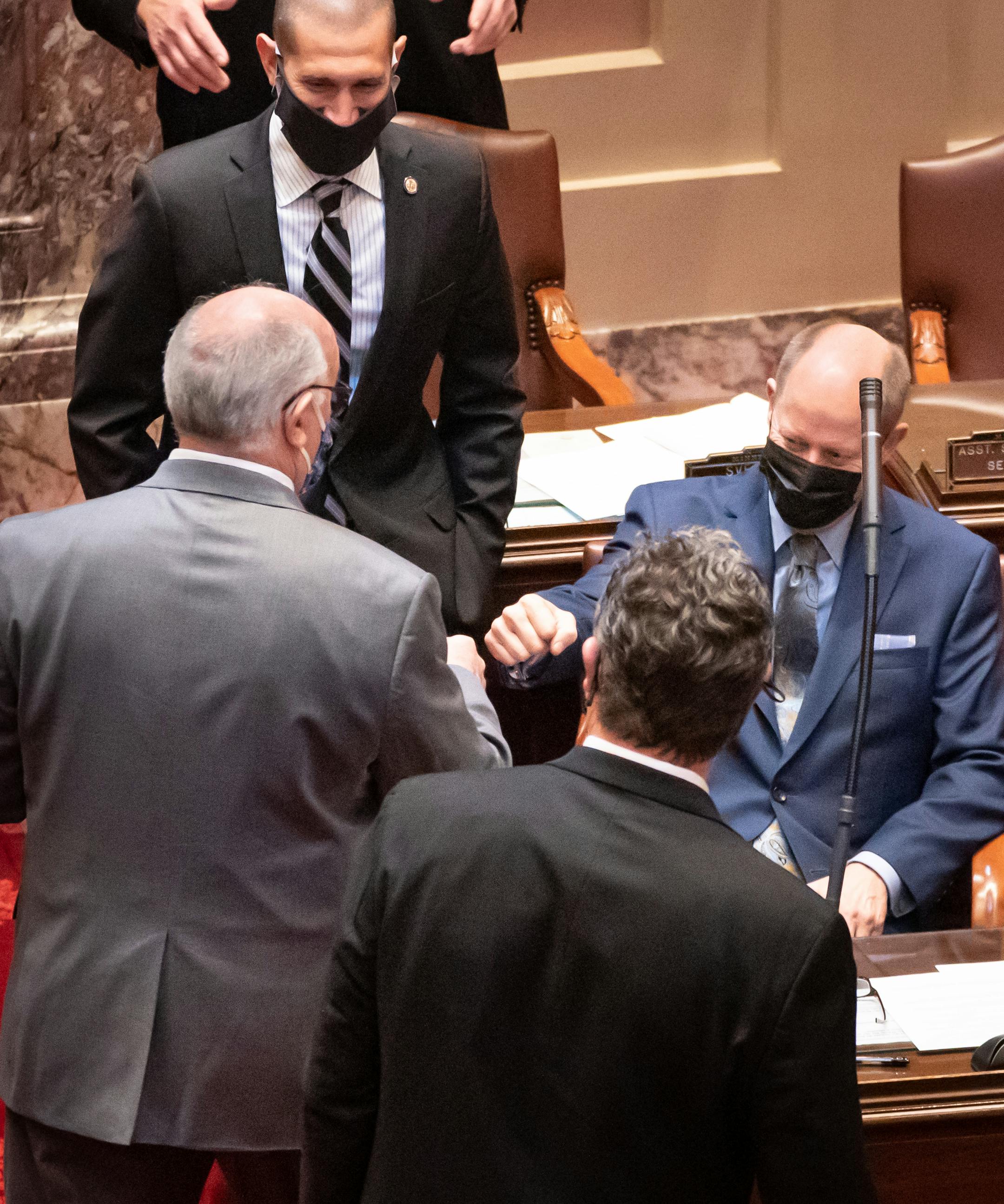 Sen. David Tomassoni, DFL-Chisholm got a fist bump from Senate Majority Leader Paul Gazelka, R-East Gull Lake after a floor fight and vote continuing his term as President-ProTem of the Senate. This measure was taken to prevent a Republican being taken as Lt. Governor in the event President Biden chooses a Minnesota Senator for a role in his administration.  In Minnesota the Senate President automatically becomes the Lt Governor. This would impact the Republicans thin majority lead.