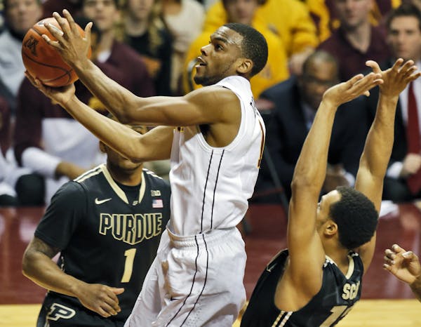 Minnesota's Andre Hollins drove through the Purdue defense for a 2nd half layup against the Boilermakers.