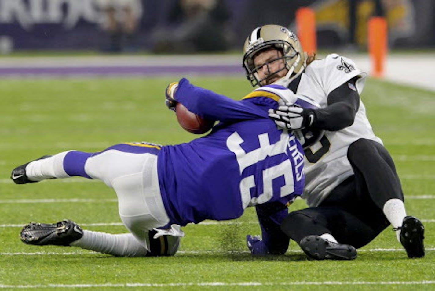 In this Jan. 14, 2018, photo, New Orleans Saints punter Thomas Morstead (6) injures his ribs on this touchdown saving tackle of Minnesota Vikings cornerback Marcus Sherels (35) in the first half of an NFC Divisional Playoff NFL football game in Minneapolis, Minn. Morstead tore cartilage on the right side of his ribs, an injury that will leave him in considerable pain for the next two weeks and won't be fully healthy for four to six weeks. (Matthew Hinton/The Advocate via AP)