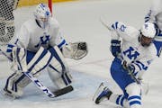 Minnetonka goalie Hunter Bauer (1) defends with the help of Javon Moore (22) at the Pagel Activity Center in Minnetonka, Minn., on Thursday, Dec. 7, 2