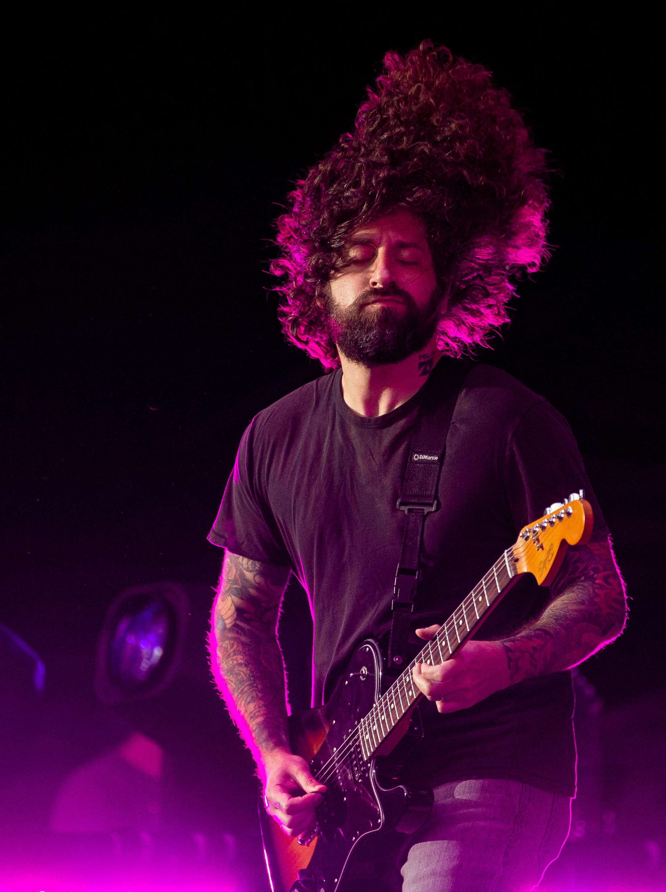 Joe Trohman, guitarist for Fall Out Boy, threw his hair back and forth during the band's opening song at the Hella Mega Tour at Target Field in Minneapolis on Monday.