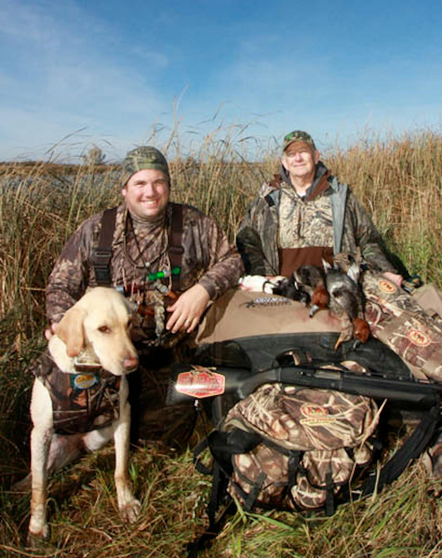 Author Ron Hustvedt, Jr and his father (Sr.) after a productive outing using jerk rigs and duck flags (and a high quality dog like Maddy the yellow lab)