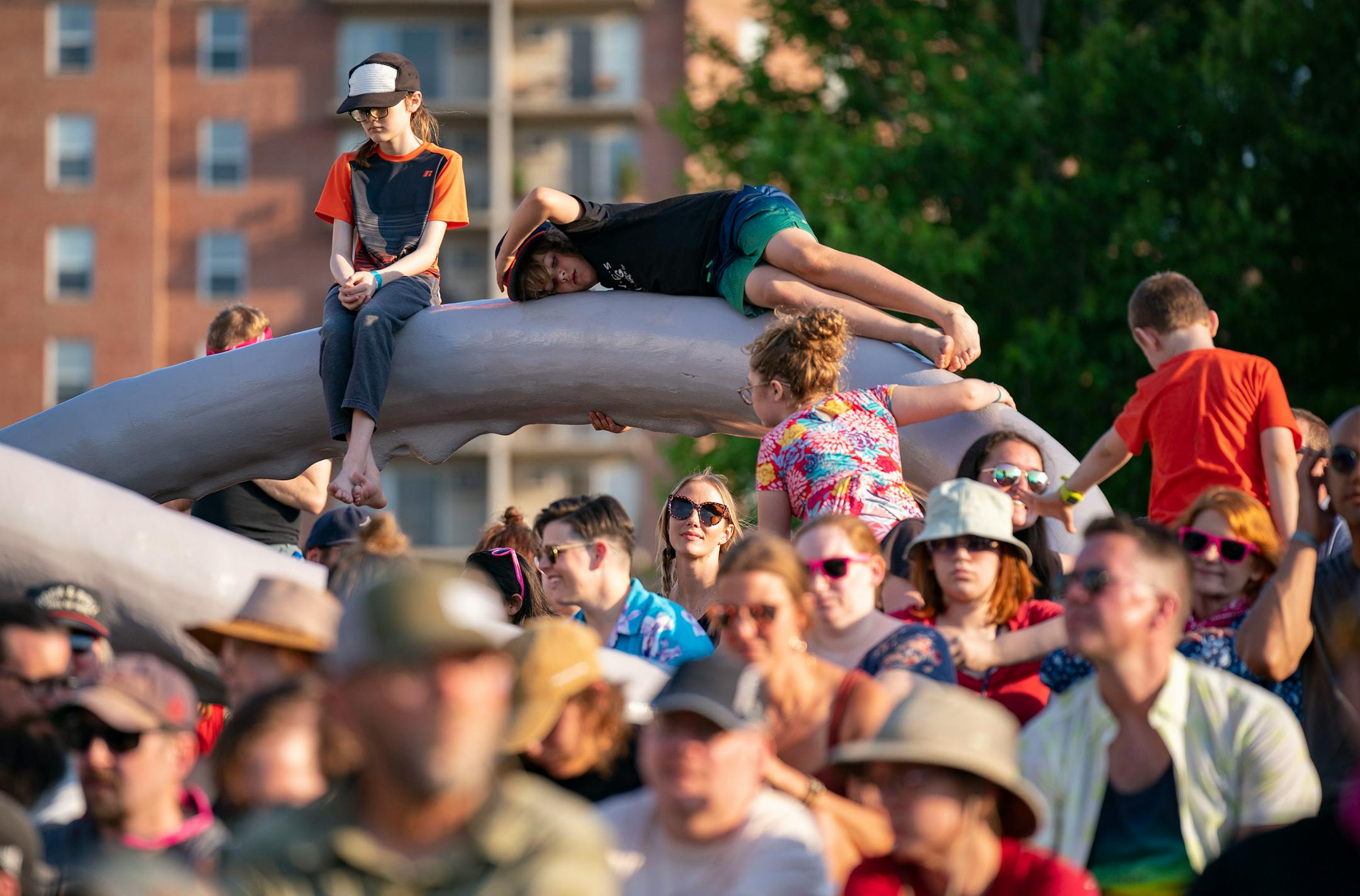 Kids play on sculptures while Sleater-Kinney performs during Rock the Garden.