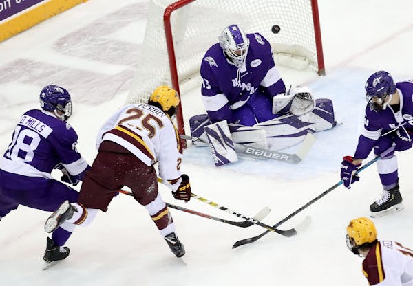 The University of Minnesota's Jack Perbix (25) can't get a shot past Niagara University goaltender Brian Wilson (33) during the first period Friday, O
