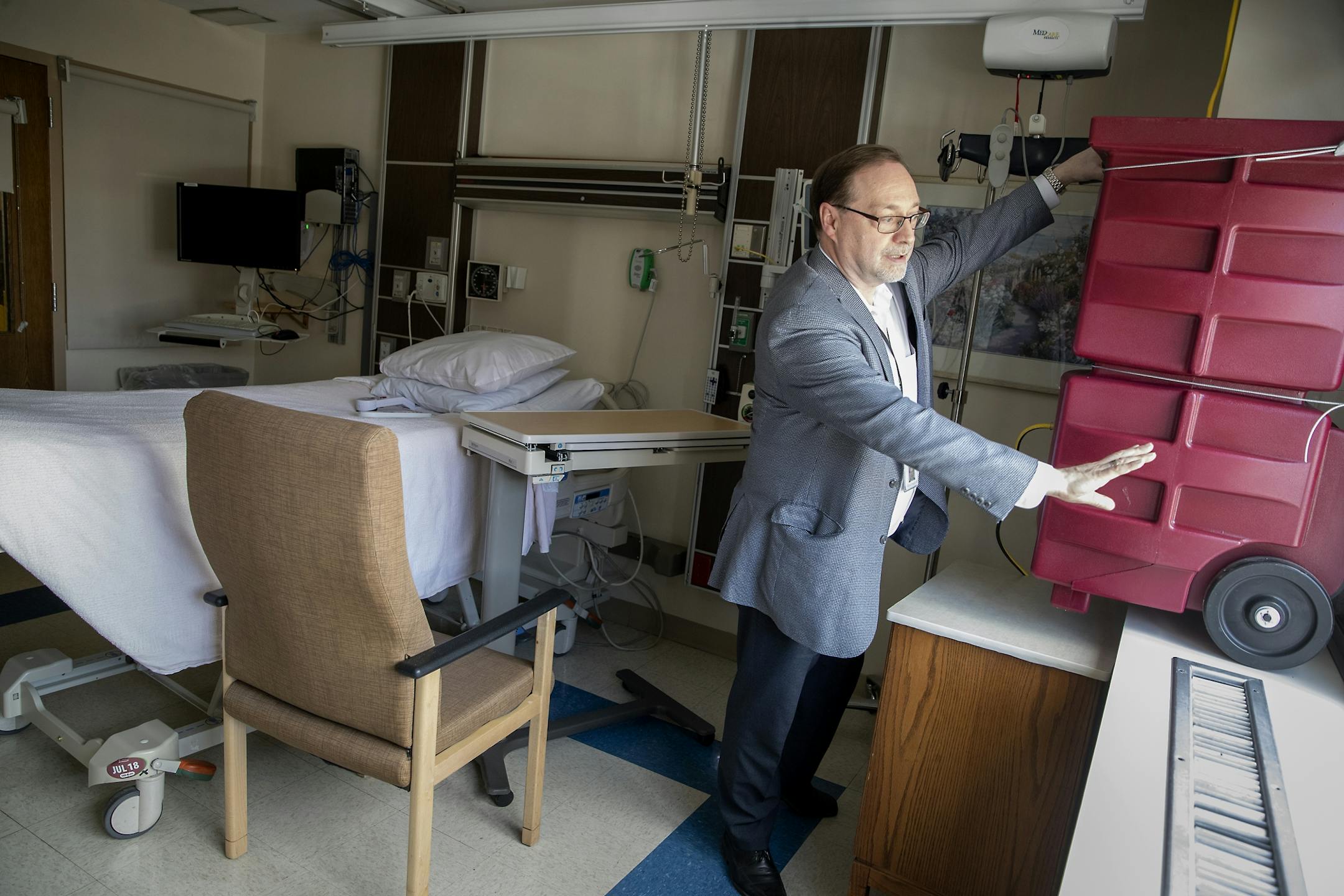 Abbott Northwestern's Director of Facilities Steve Waderich showed how the new "High Efficiency Filtration" fan units flow from the inside to the outside in an overflow area at the hospital, Tuesday, March 24, 2020 in Minneapolis, MN. The new units are being placed in 25 rooms that should be ready by tomorrow in preparation for a potential surge.