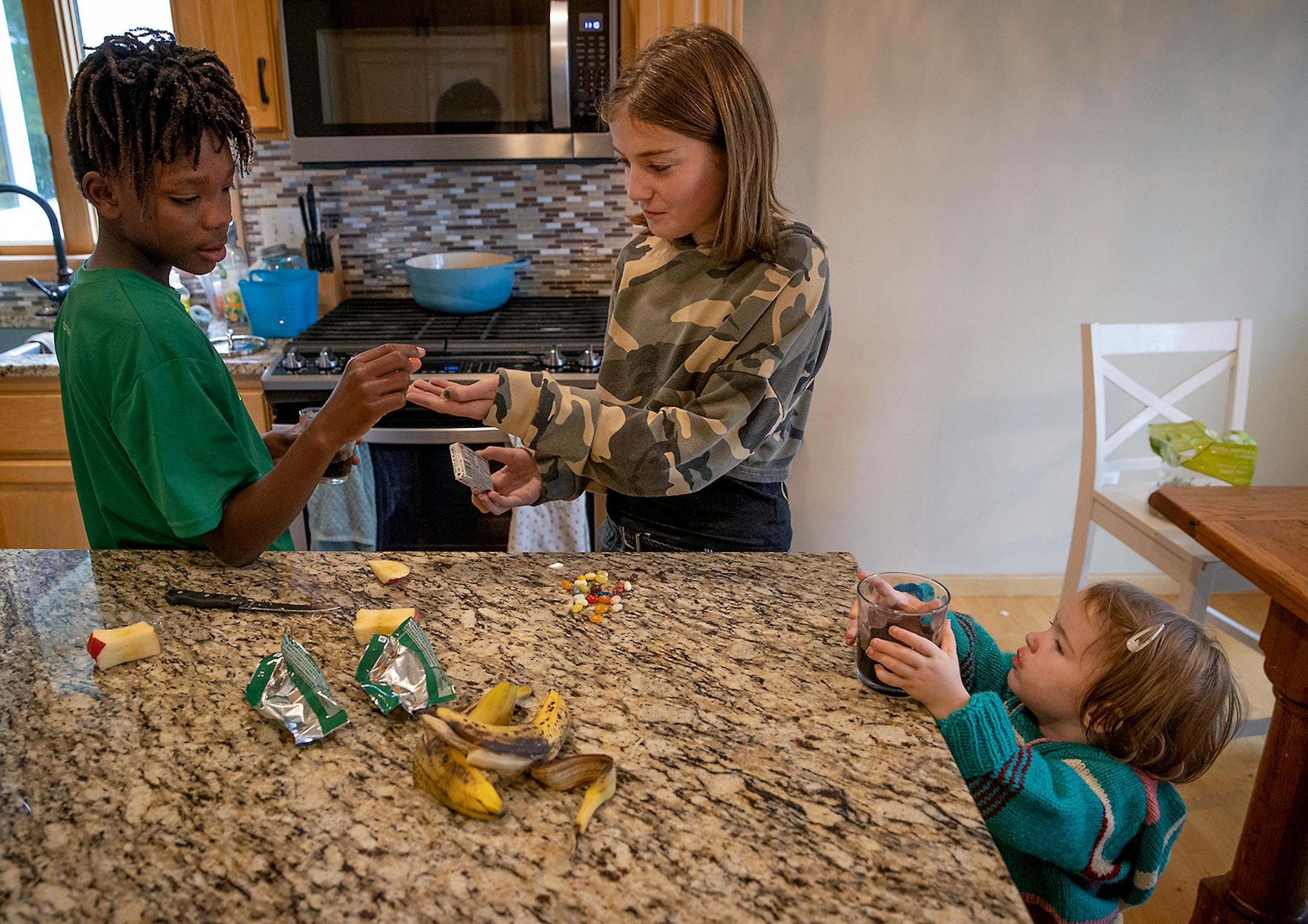Nelson Lundquist, 11, and his sisters Charlotte, 11, center, and Verabeth, 2, right, took a snack break from school work, Tuesday, September 29, 2020 in Brooklyn Park, MN.