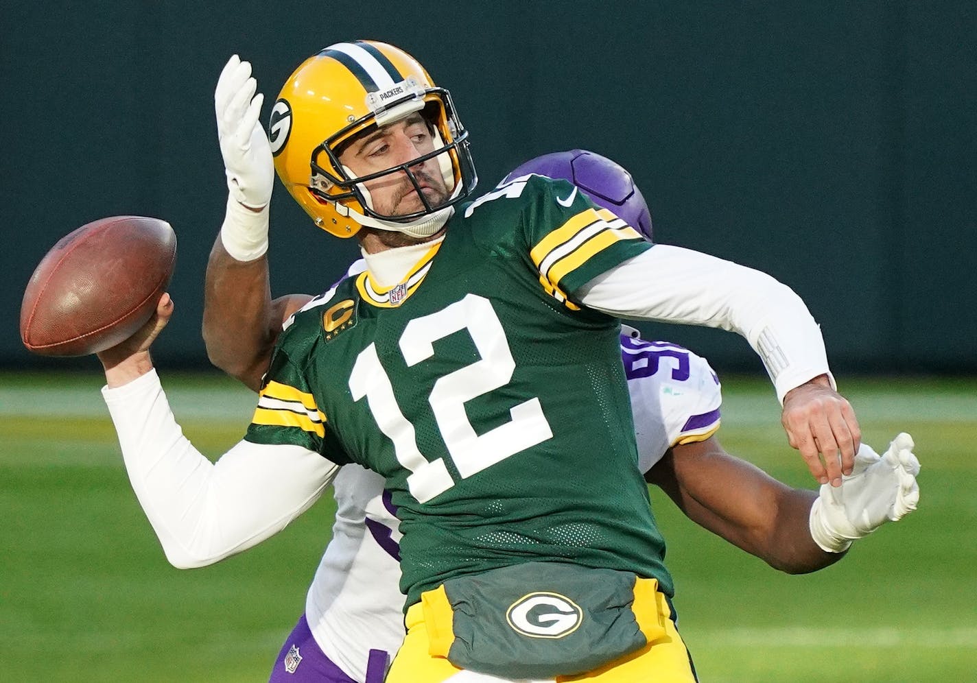 Green Bay Packers quarterback Aaron Rodgers (12) looked to make a long touchdown pass as Minnesota Vikings defensive end D.J. Wonnum (98) went in for the sack in the final few seconds in the fourth quarter. ] ANTHONY SOUFFLE • anthony.souffle@startribune.com