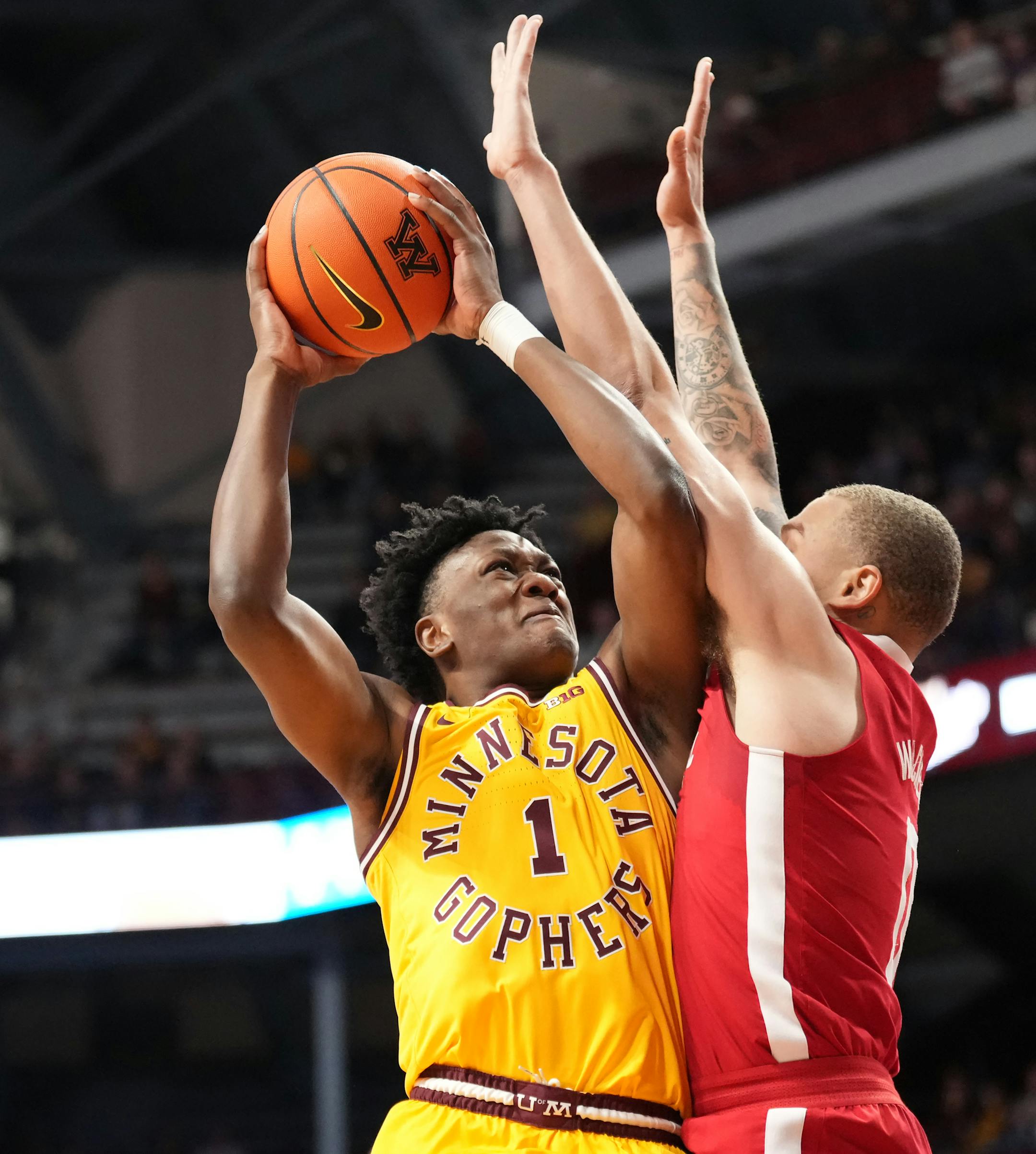 Minnesota Golden Gophers forward Joshua Ola-Joseph (1) gets a shot off while defended by Nebraska Cornhuskers guard C.J. Wilcher (0) in the first half.