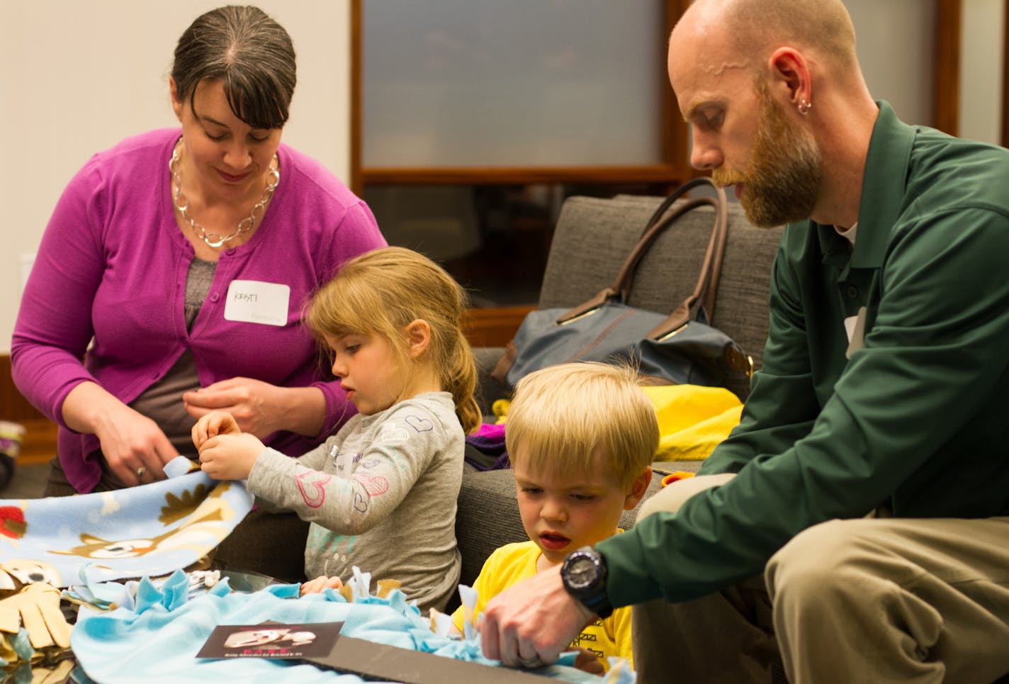 Kristi, Margaret, Evan and Ryan Osgood at a Doing Good Together&#xf4; Family Service Fair at Piper Jaffray in 2014.