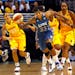 Minnesota Lynx's Seimone Augustus (33) steals the ball as Los Angeles Sparks guard Ticha Penicheiro (21) watches during the first quarter of a WNBA ba