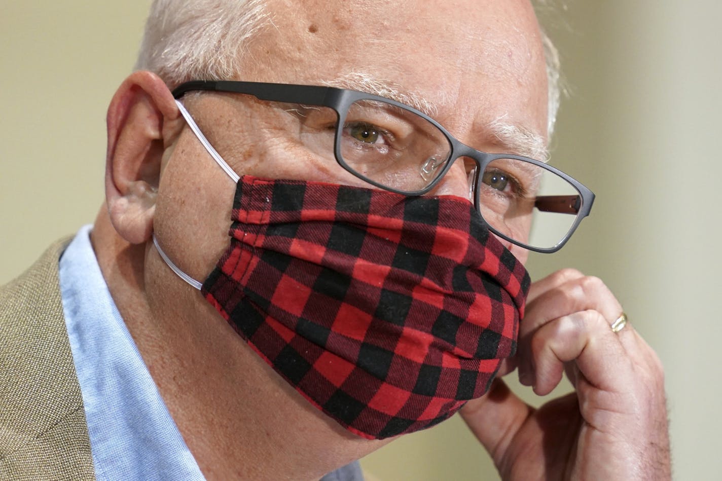 Minnesota Gov. Tim Walz wore his buffalo plaid cloth mask at a July 22 news conference. He thanked Minnesotans on Monday for a recent hike in mask-wearing and said it should be a bridge to a COVID-19 vaccine.