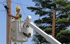 Seth Kern, with Lake States Construction, a sub-contractor of Lake Connections, readied telephone poles in Two Harbors to string stainless steel stran