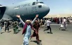 Hundreds of people ran alongside a U.S. Air Force C-17 transport plane in August as it moved down a runway of the international airport in Kabul, Afgh