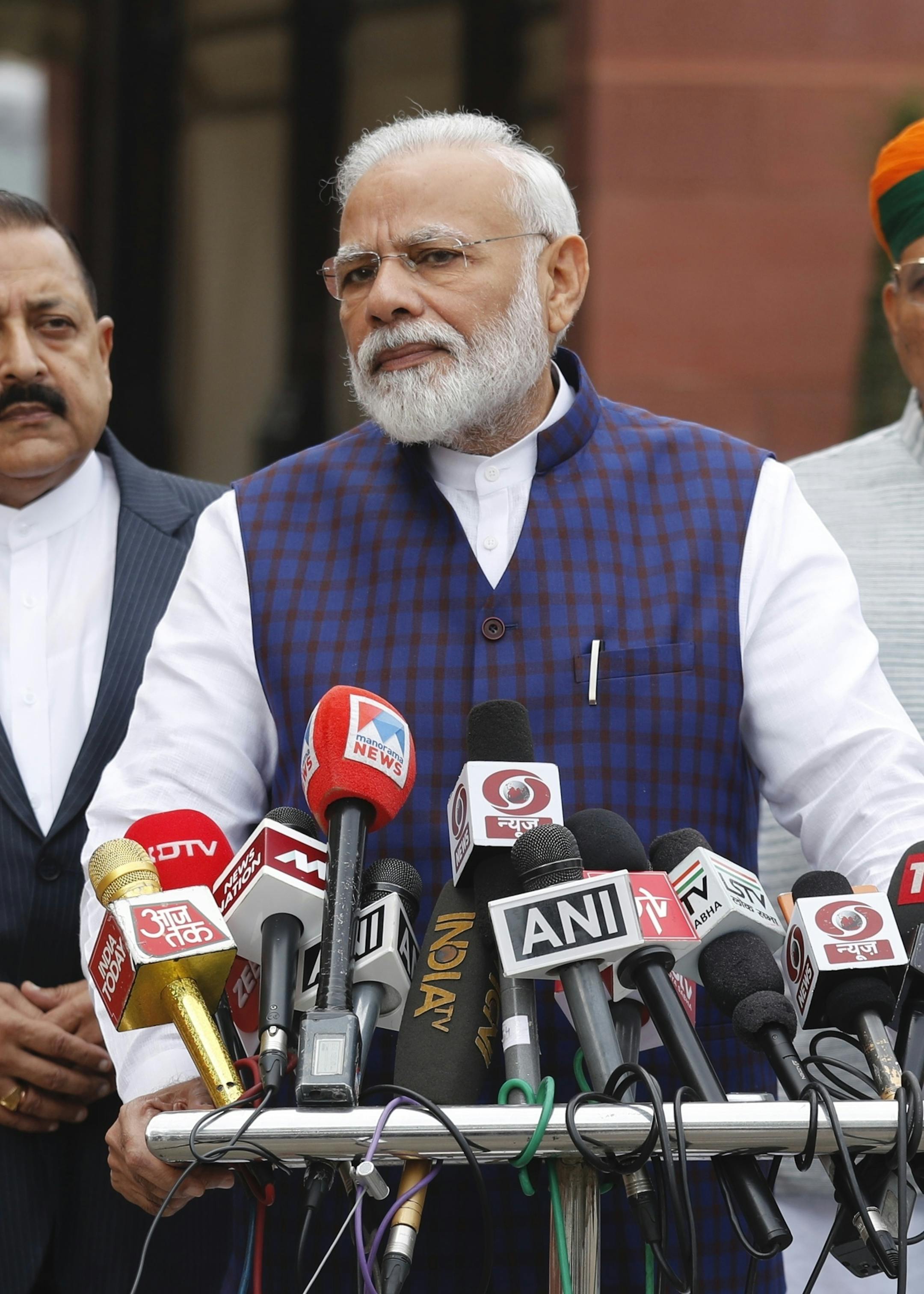 Indian Prime Minister Narendra Modi, center, addresses the media on the opening day of the winter session of the Parliament in New Delhi, India, Monday, Nov.18, 2019. (AP Photo/Manish Swarup)
