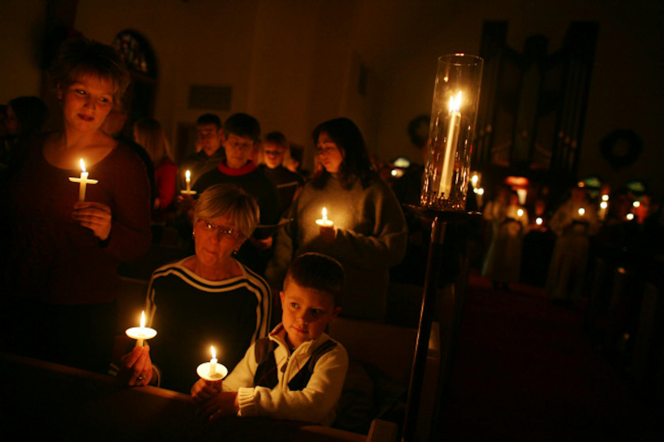 Kelley Quarne, left, along with her mother, Sylvia Emerson, and her son, Jakob Quarne, 6, of Roberts, Wis., took part in Christmas Eve services at Bethlehem Lutheran Church in Bayport. The flame that lit their candles — the International Peace Light — came from Bethlehem.