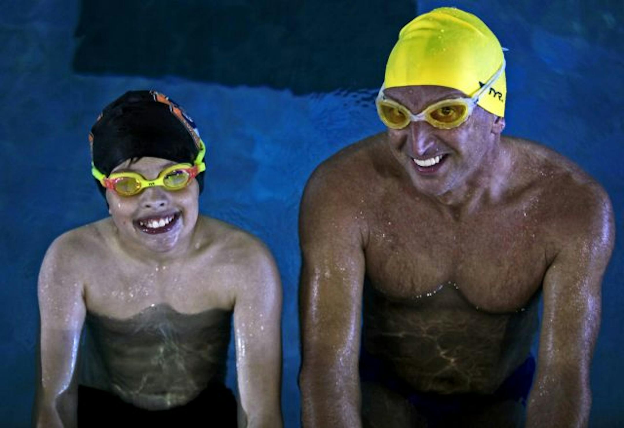 Brian Maas, right and his son Graham Maas, 10 swam together during a recent workout at Life Time Fitness club in Plymouth.