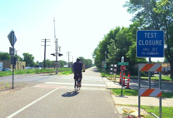 A bicyclist rides on the Midtown Greenway at 29th Avenue.
