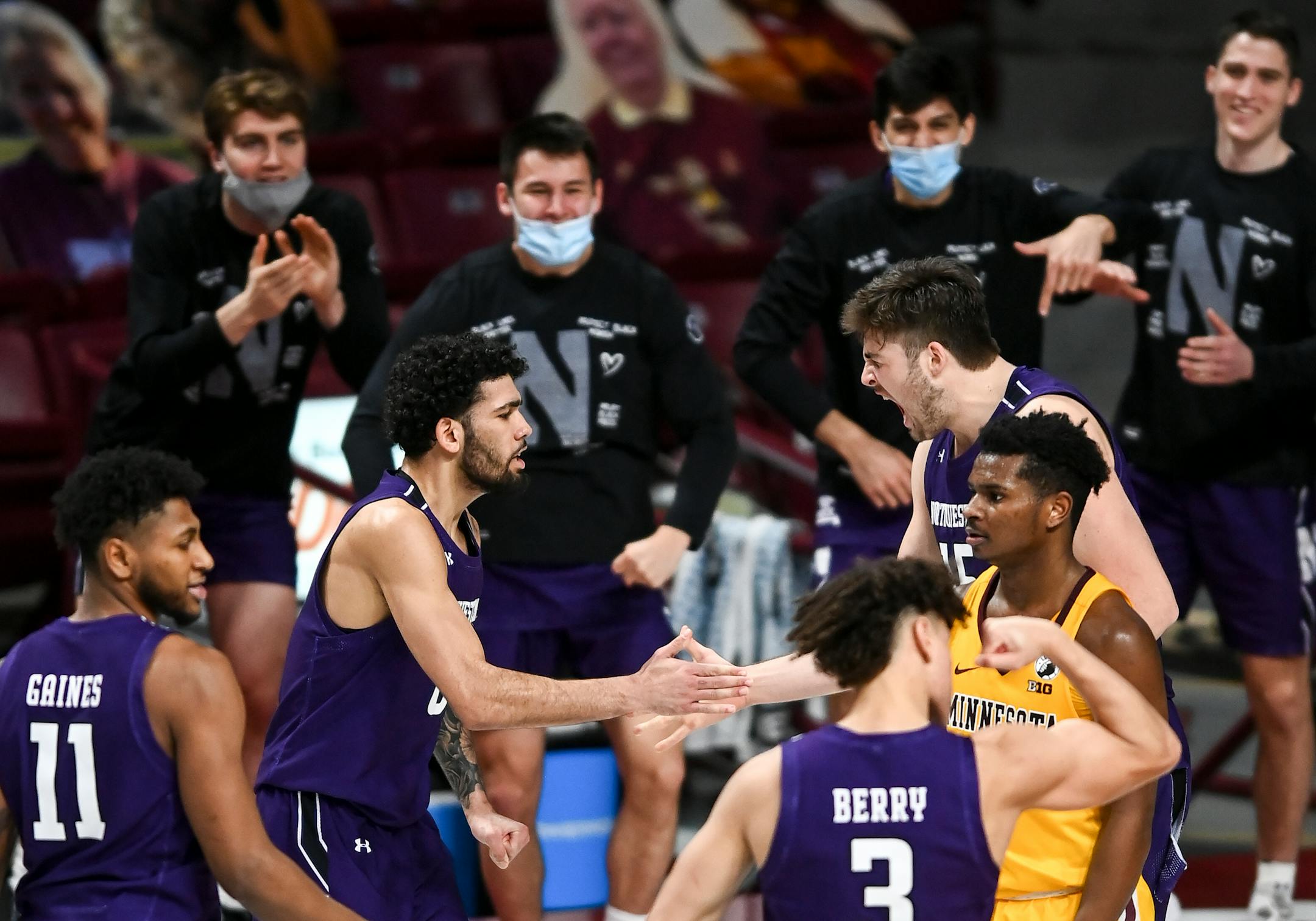 Northwestern Wildcats guard Boo Buie (0), left of center, celebrated with center Ryan Young (15) after a 3-pointer by Young early in the second half.