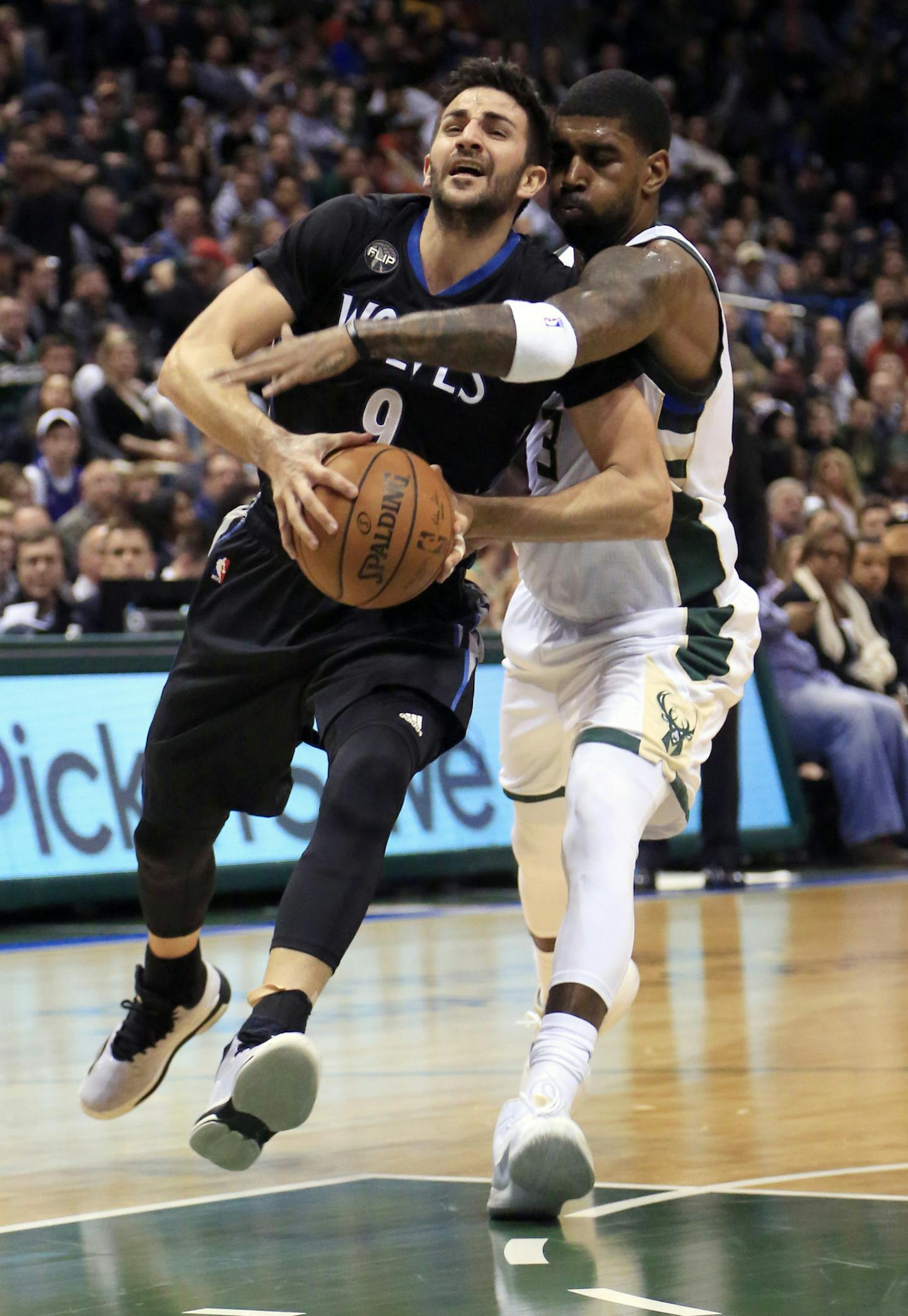 Milwaukee Bucks guard O.J. Mayo, right, fouls Minnesota Timberwolves guard Ricky Rubio, left, during the first half of an NBA basketball game Friday, March 4, 2016, in Milwaukee. (AP Photo/Darren Hauck)