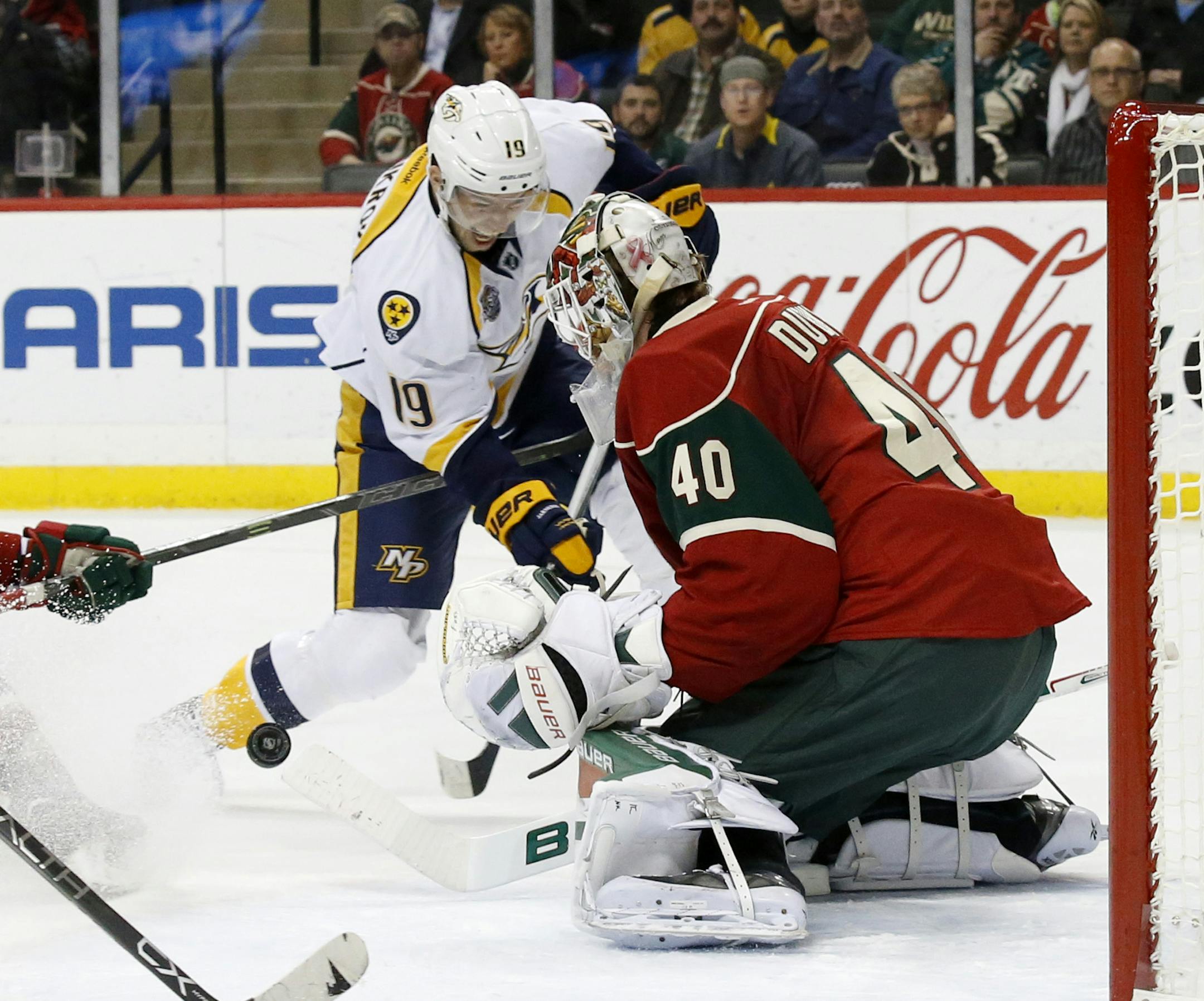 Minnesota Wild goalie Devan Dubnyk (40) deflects a point-blank shot by Nashville Predators center Calle Jarnkrok (19), of Sweden, during the second period of an NHL hockey game in St. Paul, Minn., Saturday, Nov. 21, 2015. (AP Photo/Ann Heisenfelt)