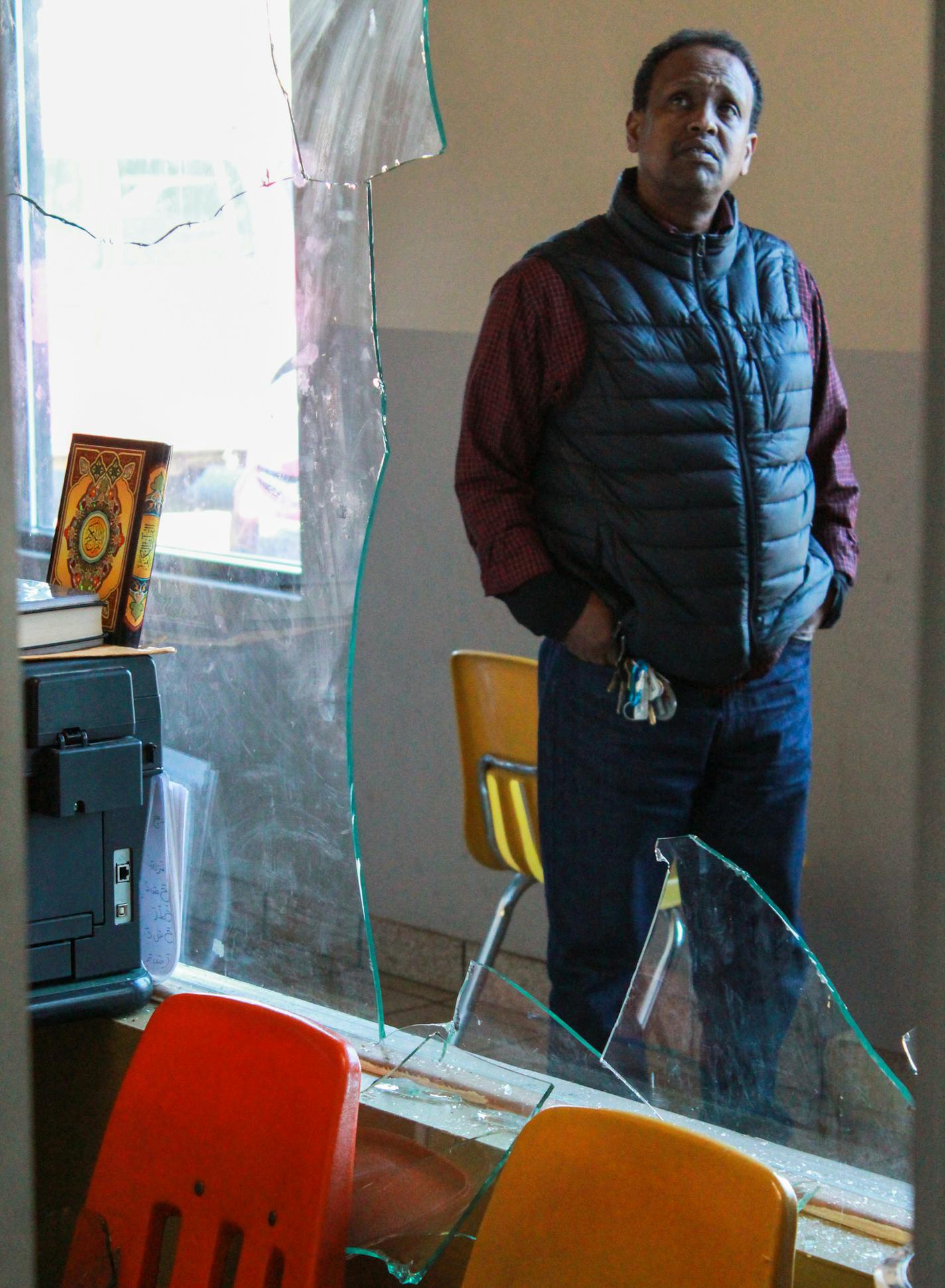 205860 2mosque - Ali Maxy looks at the damage done to the mosque's office window. ] Sophie Hoover Star Tribune Intern