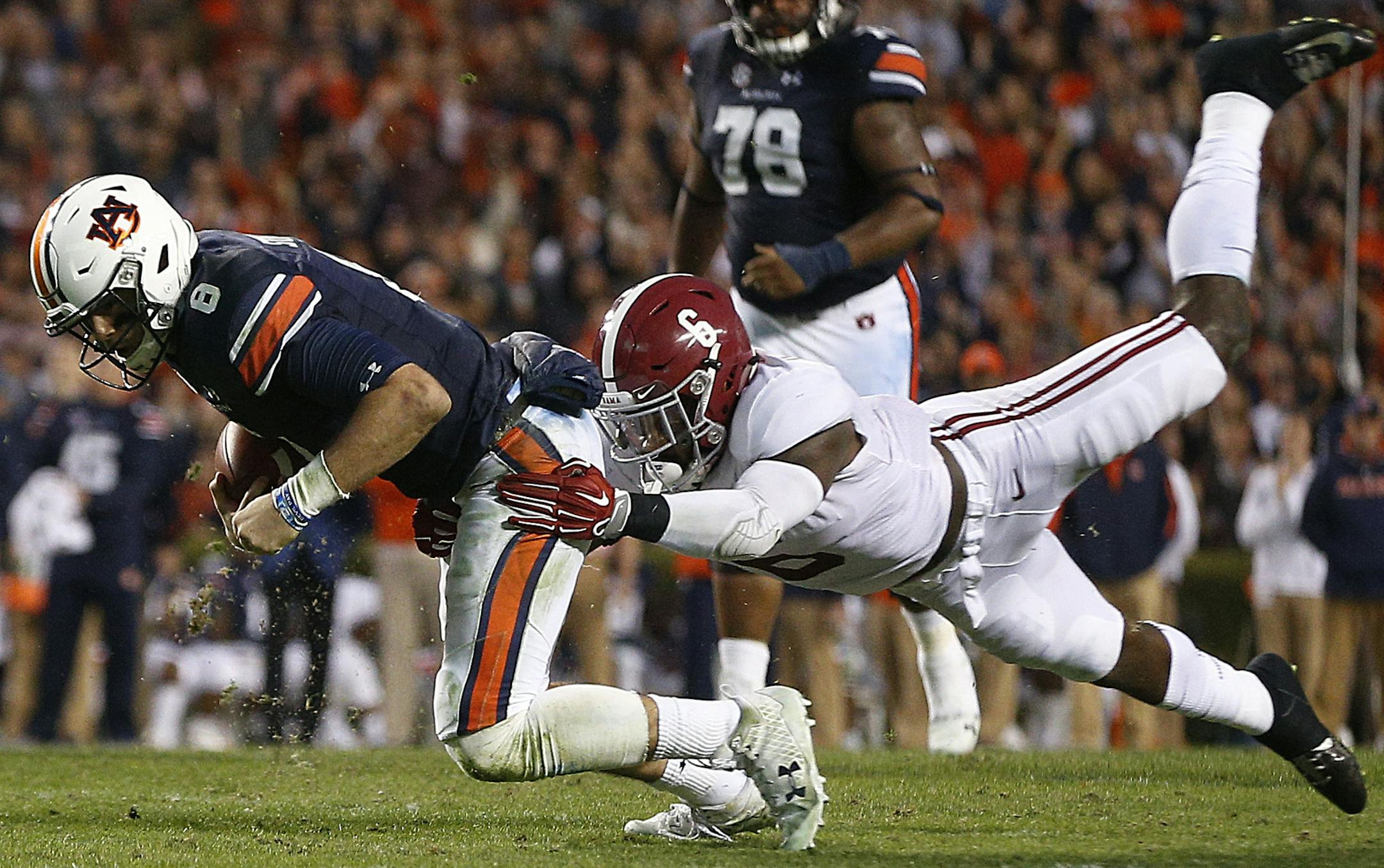 Alabama defensive back Hootie Jones (6) tackles Auburn quarterback Jarrett Stidham (8) during the second half of the Iron Bowl NCAA college football game, Saturday, Nov. 25, 2017, in Auburn, Ala. (AP Photo/Brynn Anderson)