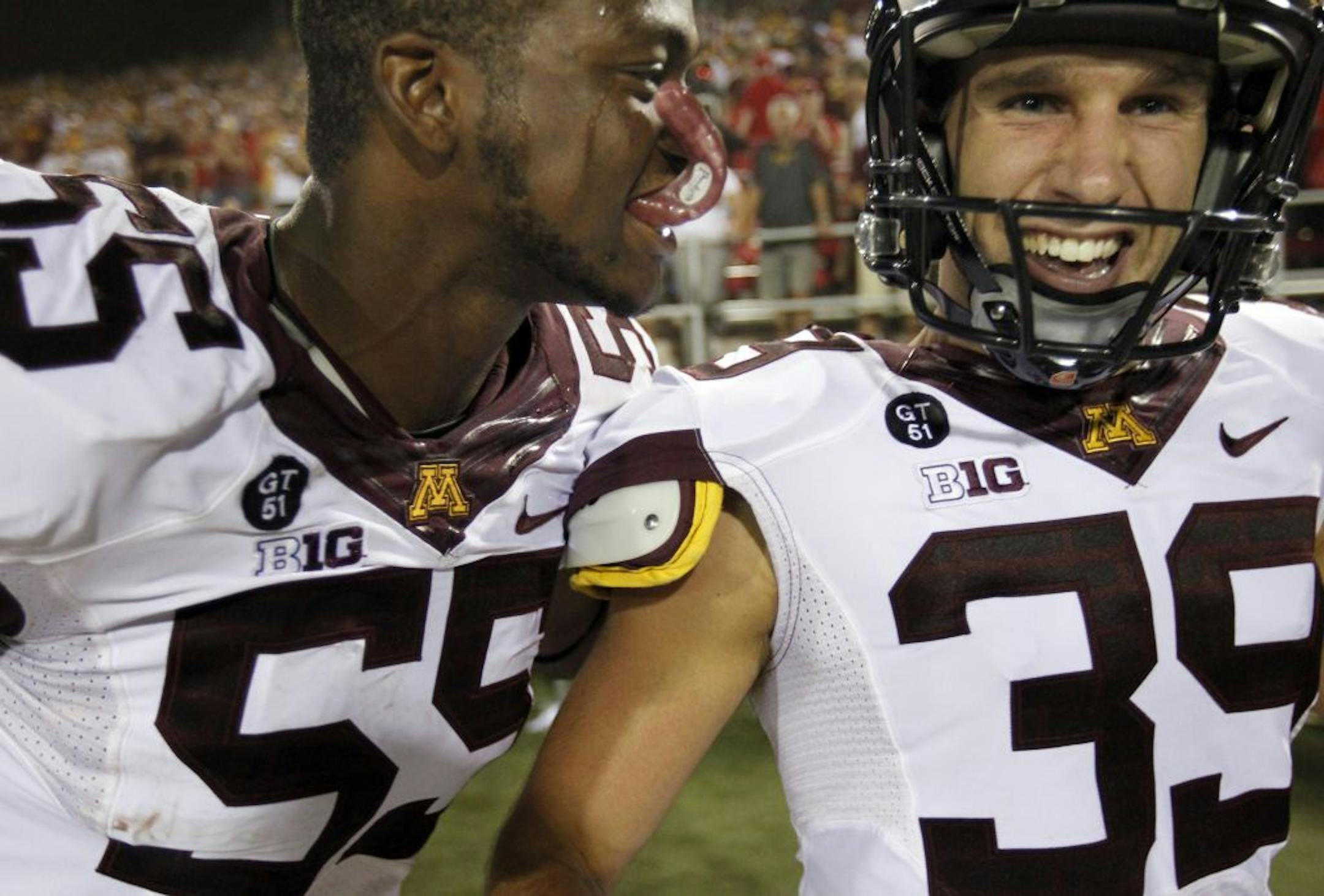 Thieren Cockran (55) celebrated with Jordan Wettstein after Wettstein kicked the game-winning field goal in the Gophers' 30-27 victory over UNLV in triple overtime.