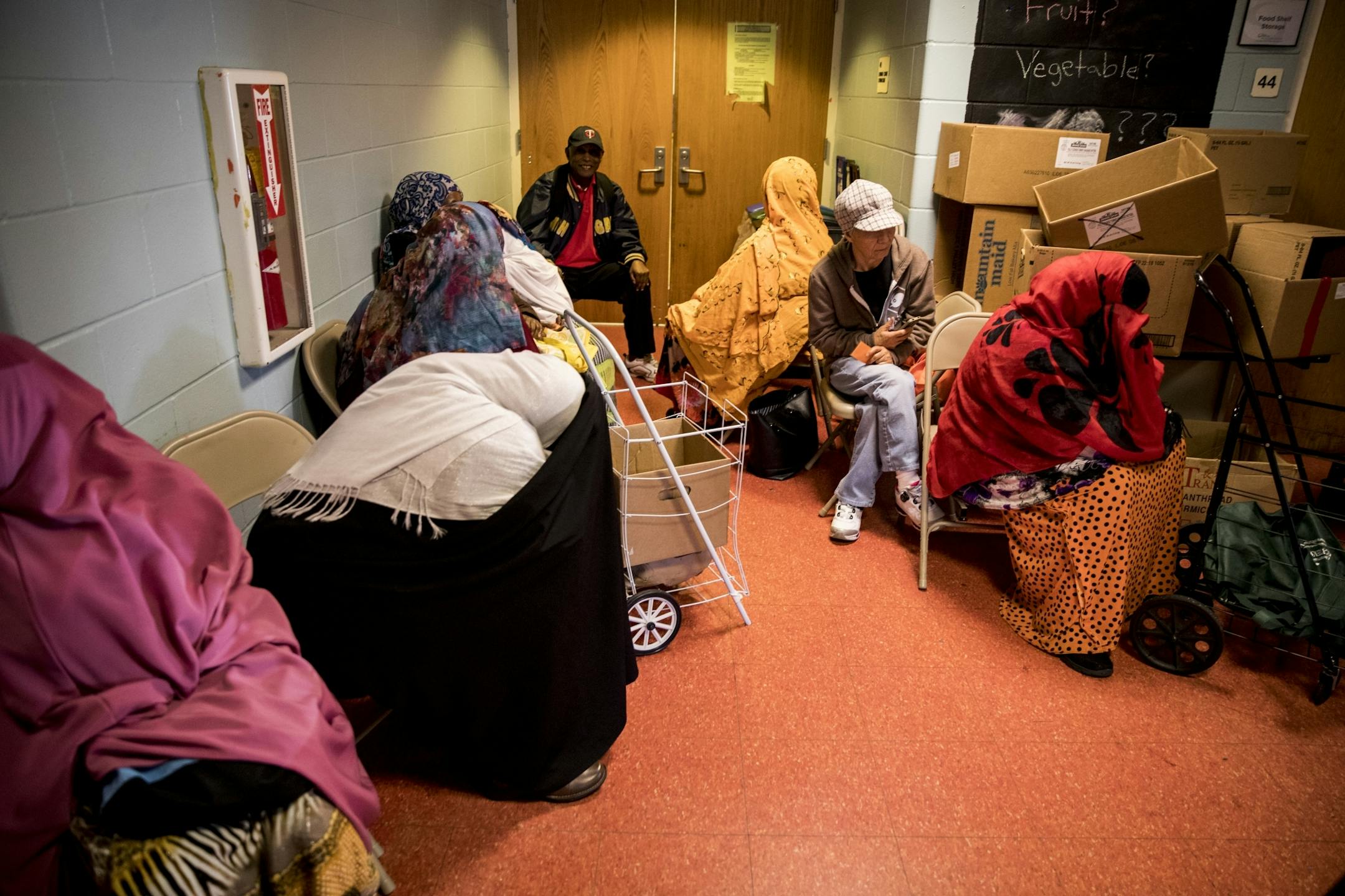 A group of people waited in the hallway at the Brian Coyle Center for their number to be called at the food shelf on Monday, October 24, 2016, in Minneapolis, Minn.
