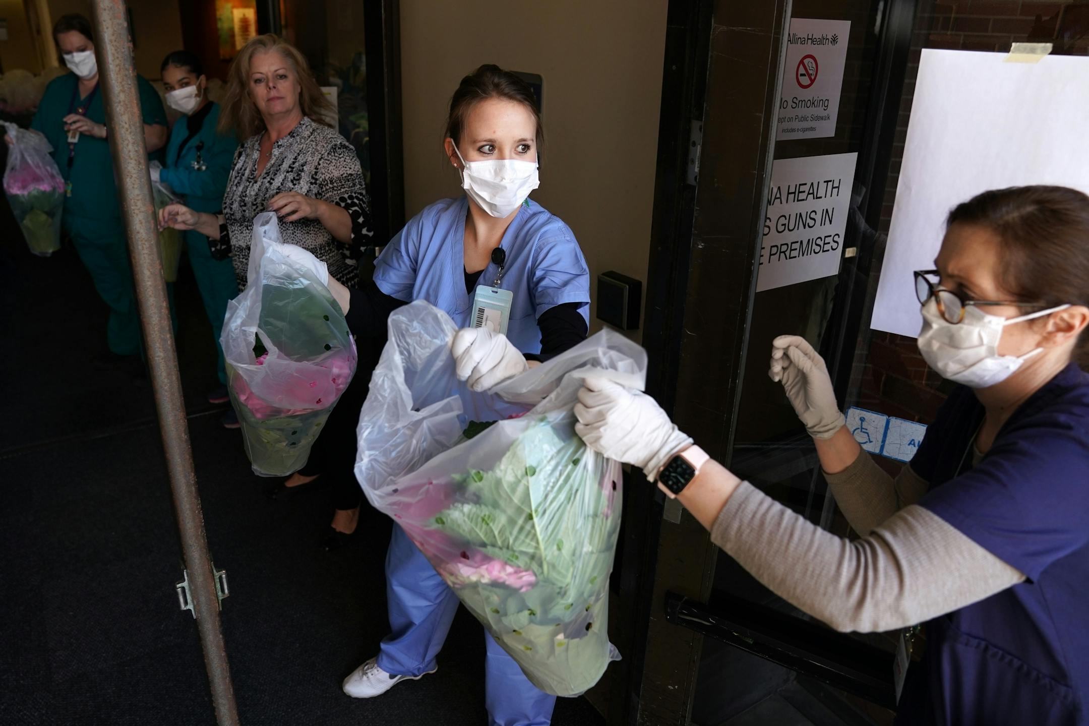 Abbott Northwestern Hospital workers formed a line as they helped unload 1,500 flowering spring plants donated by Bachman's Floral, Home & Garden in appreciation of the efforts of health care workers responding to the Coronavirus pandemic Tuesday.