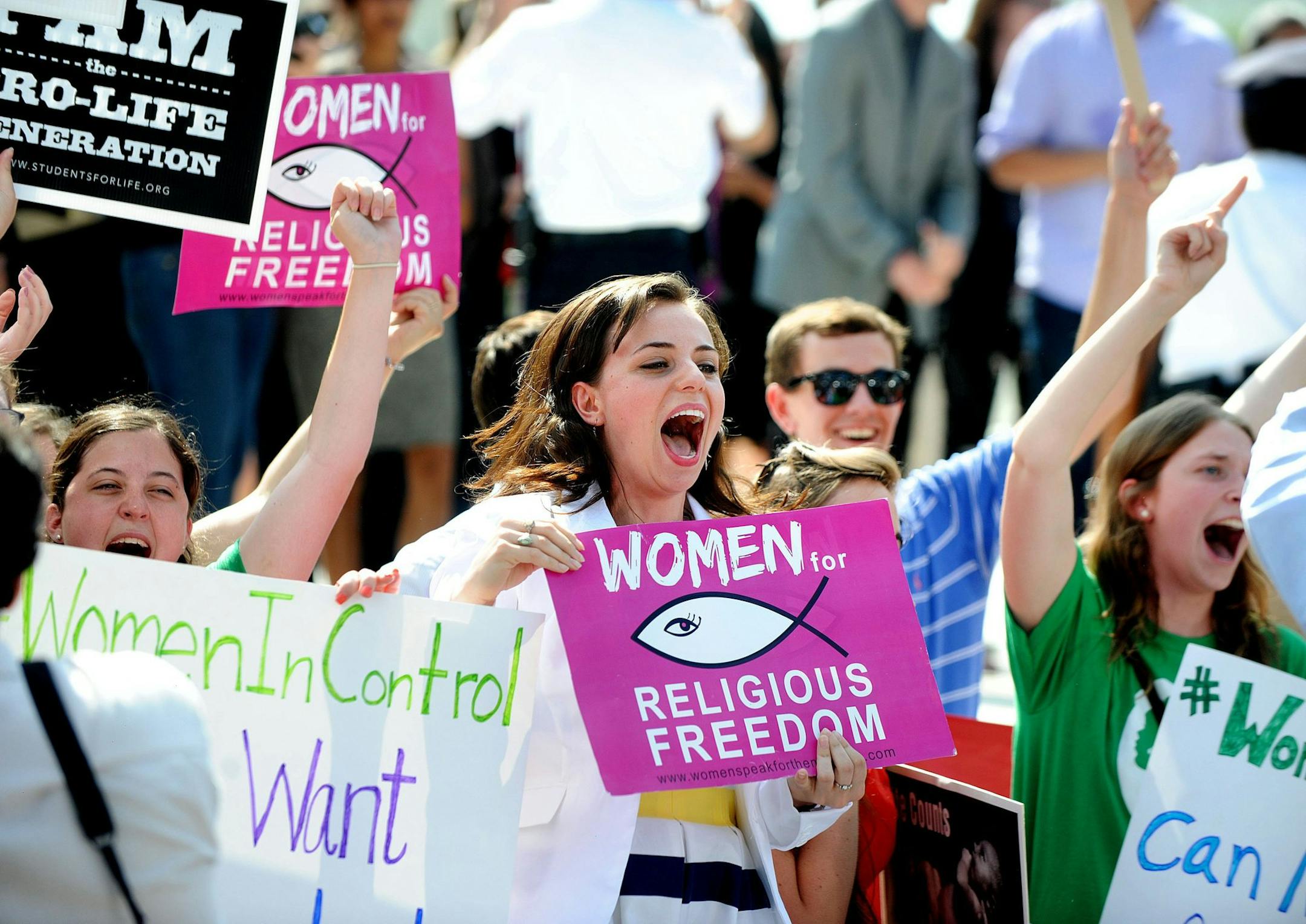 Hobby Lobby supporters react to the U.S. Supreme Court decision June 30, 2014 in Washington, DC.