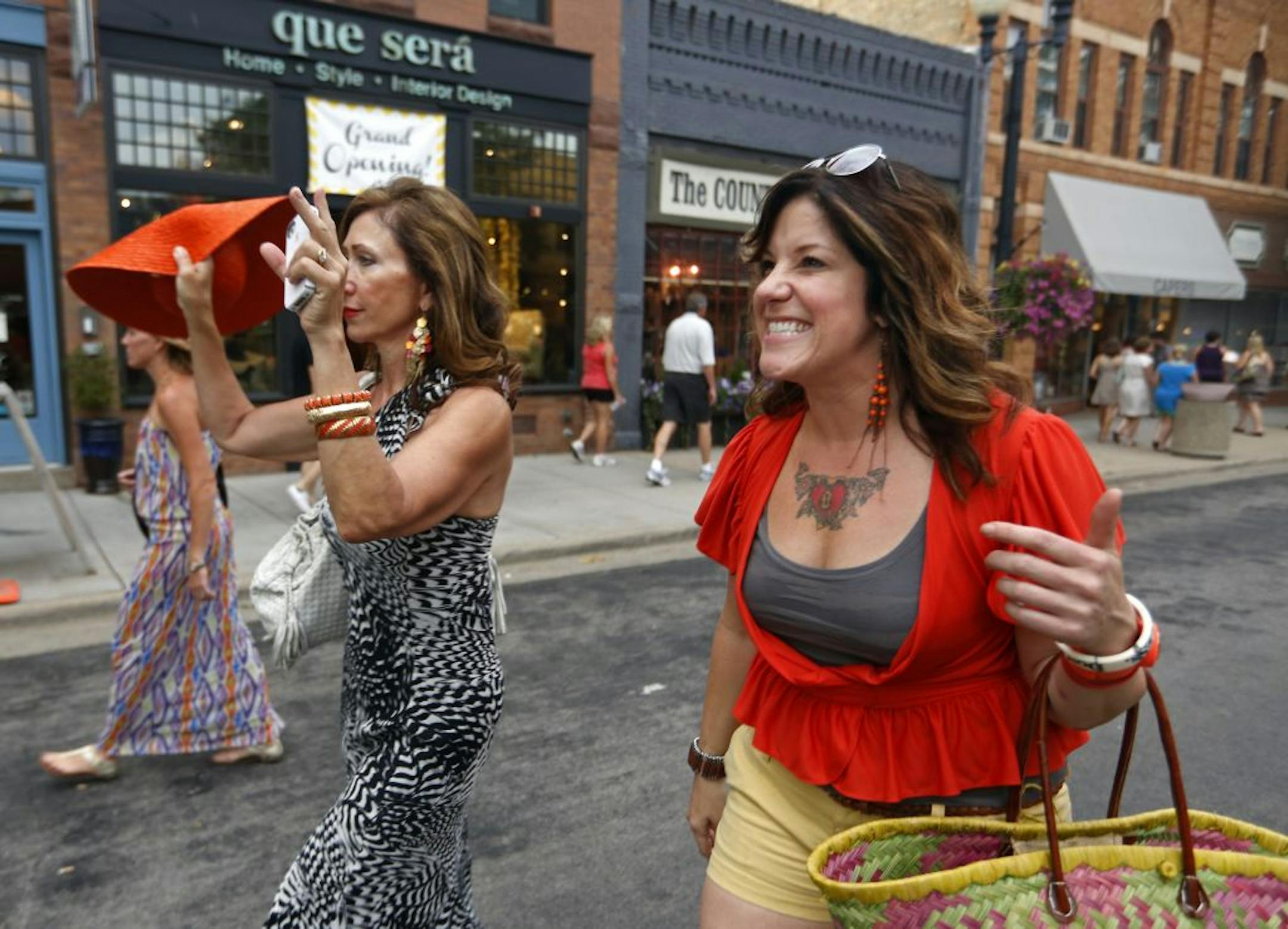 Friends Georgia Ehrreich and Amy Wagner greeted friends while hanging out and shopping during a recent "Girls Night Out" in downtown Excelsior.