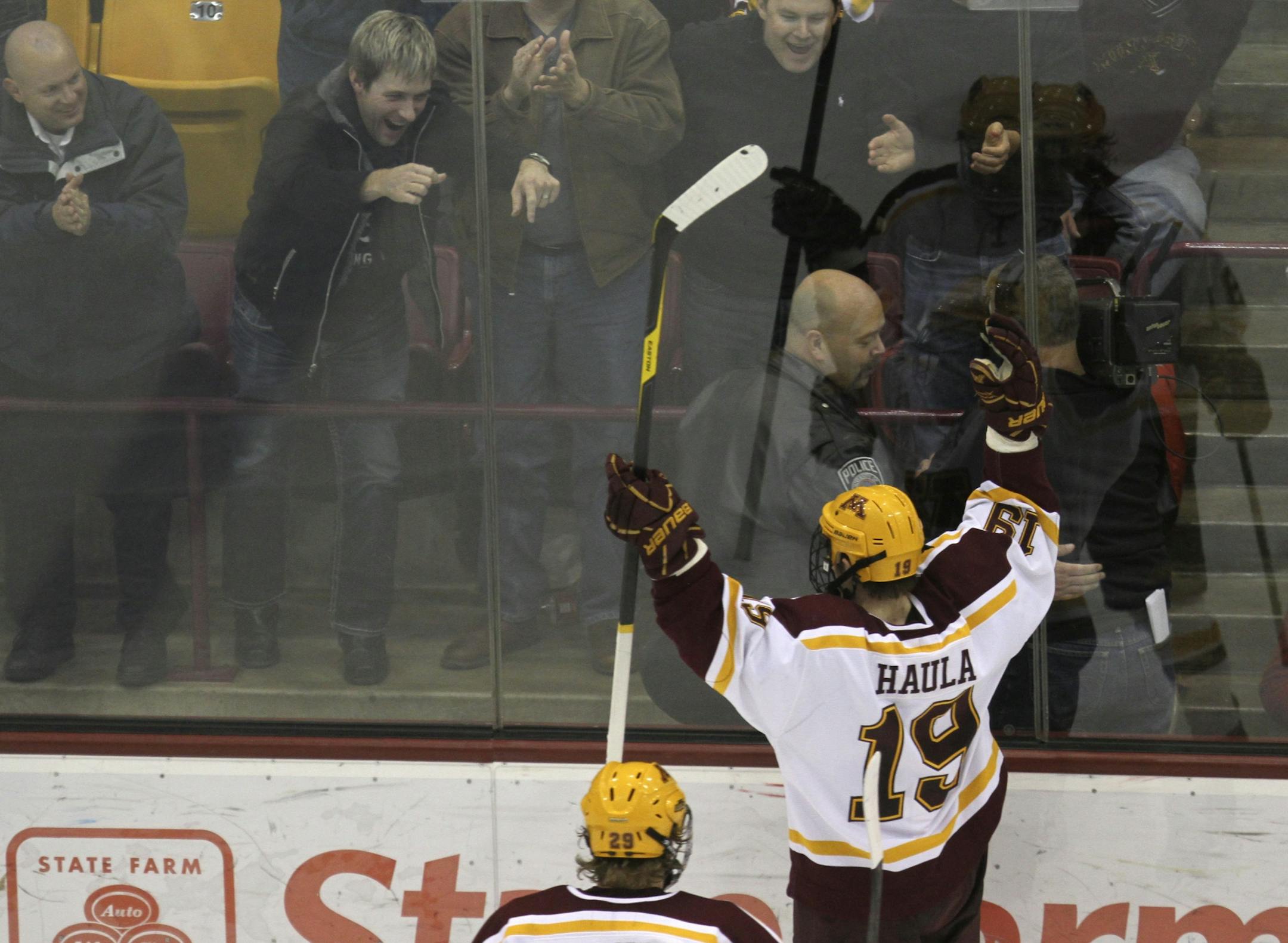 Gopher's Erik Haula celebrated with fans after scoring the go ahead goal during the third period at Mariucci Arena in Minneapolis, Min., Friday, December 2, 2011.