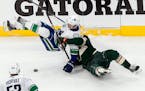 The Wild's Joel Eriksson Ek, right, hauled down Vancouver's Loui Eriksson for one of 11 Minnesota penalties in Game 3.