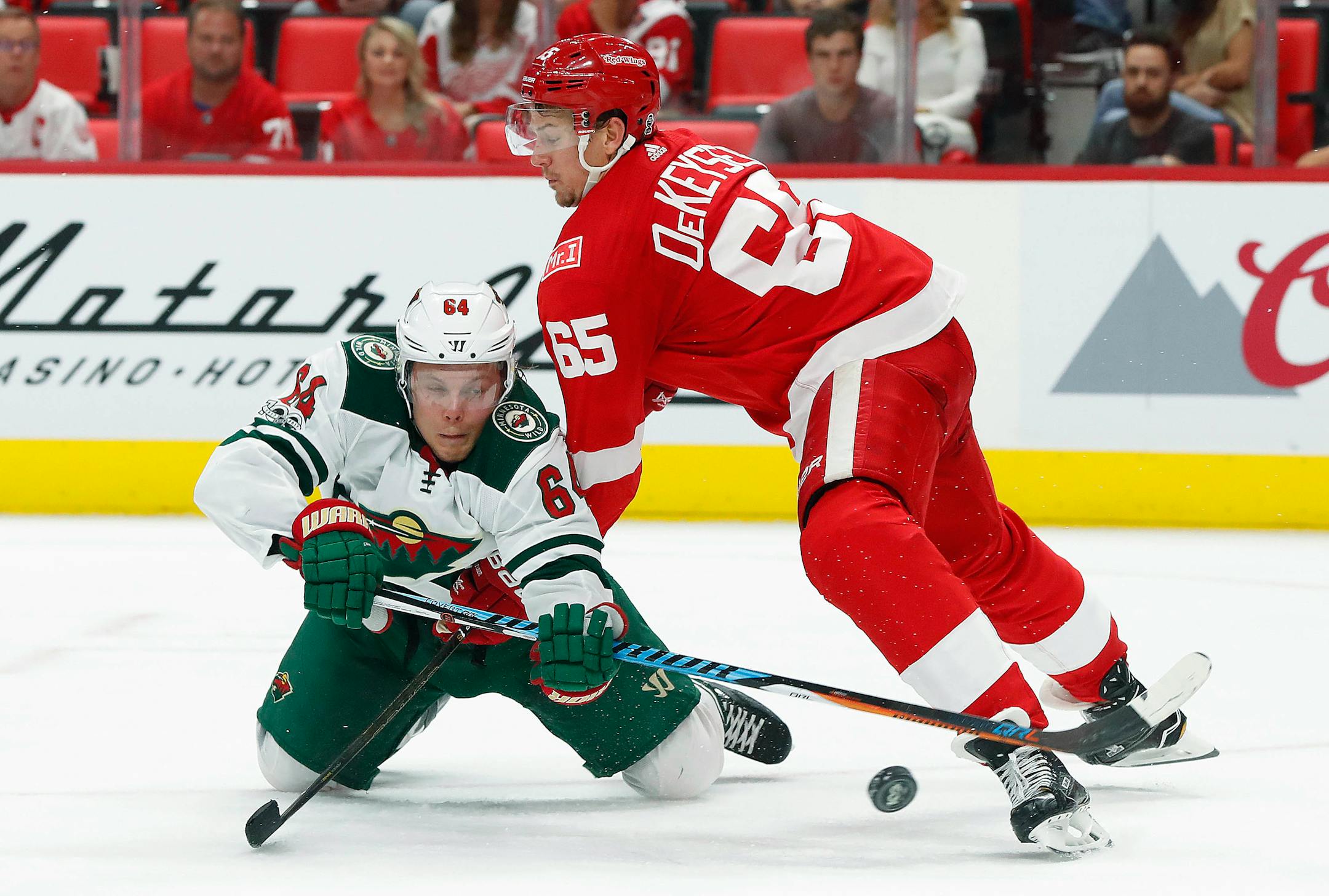 Red Wings defenseman Danny DeKeyser (65) checked Wild right winger Mikael Granlund as he tried to shoot in the third period Thursday.