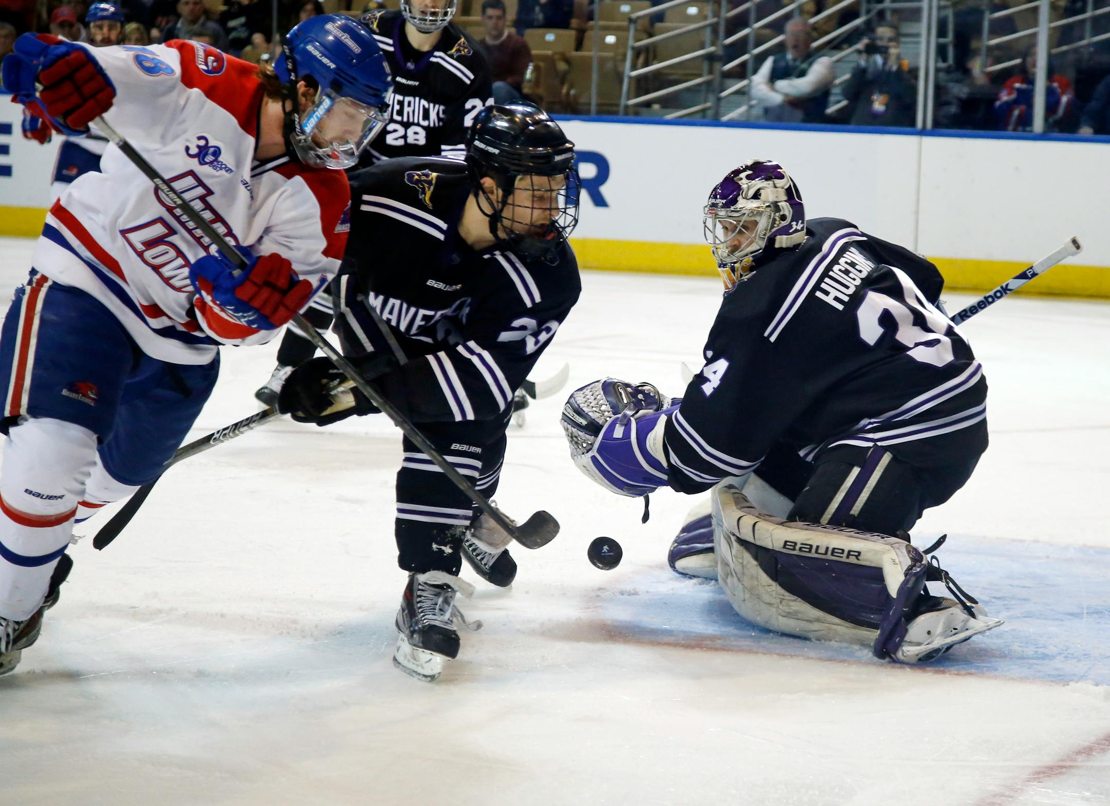 Minnesota State, Mankato's Teddy Blueger (23) keeps UMass Lowell's A.J. White (18) from the puck as goalie Cole Huggins protects the net in the first period of an NCAA Northeast Regional men's college hockey game in Worcester, Mass., Saturday, March 29, 2014. (AP Photo/Elise Amendola)