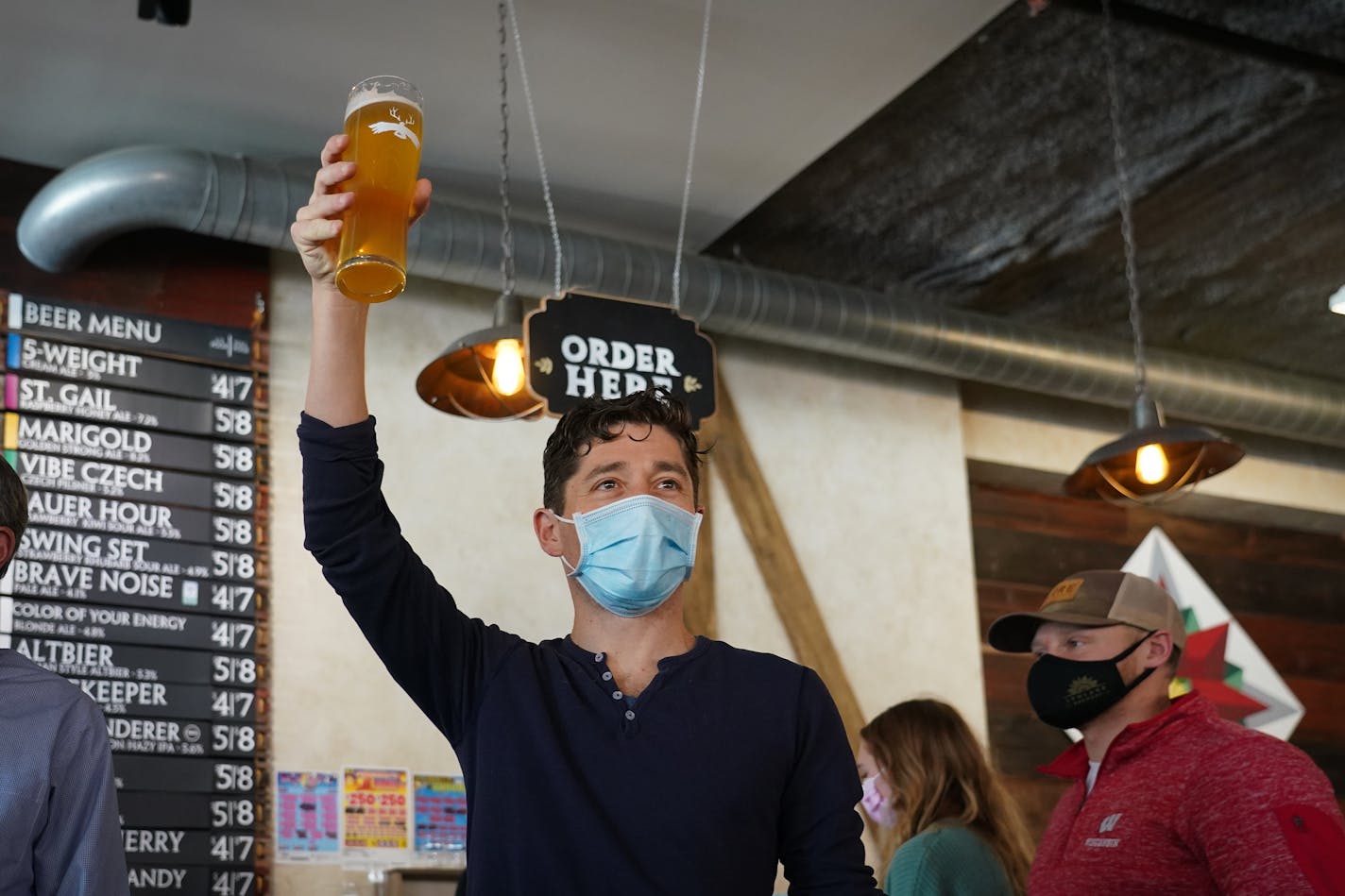 Minneapolis Mayor Jacob Frey visited Lakes &amp; Legends Brewing Company, in Minneapolis, Minn., Saturday, Dec. 11, 2021. Frey stopped by the brewery to tout the economic and cultural resurgence of downtown Minneapolis and the Loring Park neighborhood. In this photo, Frey raises a glass of 5-Weight Cream Ale after toasting the brewery's sixth anniversary.] SHARI L. GROSS • shari.gross@startribune.com