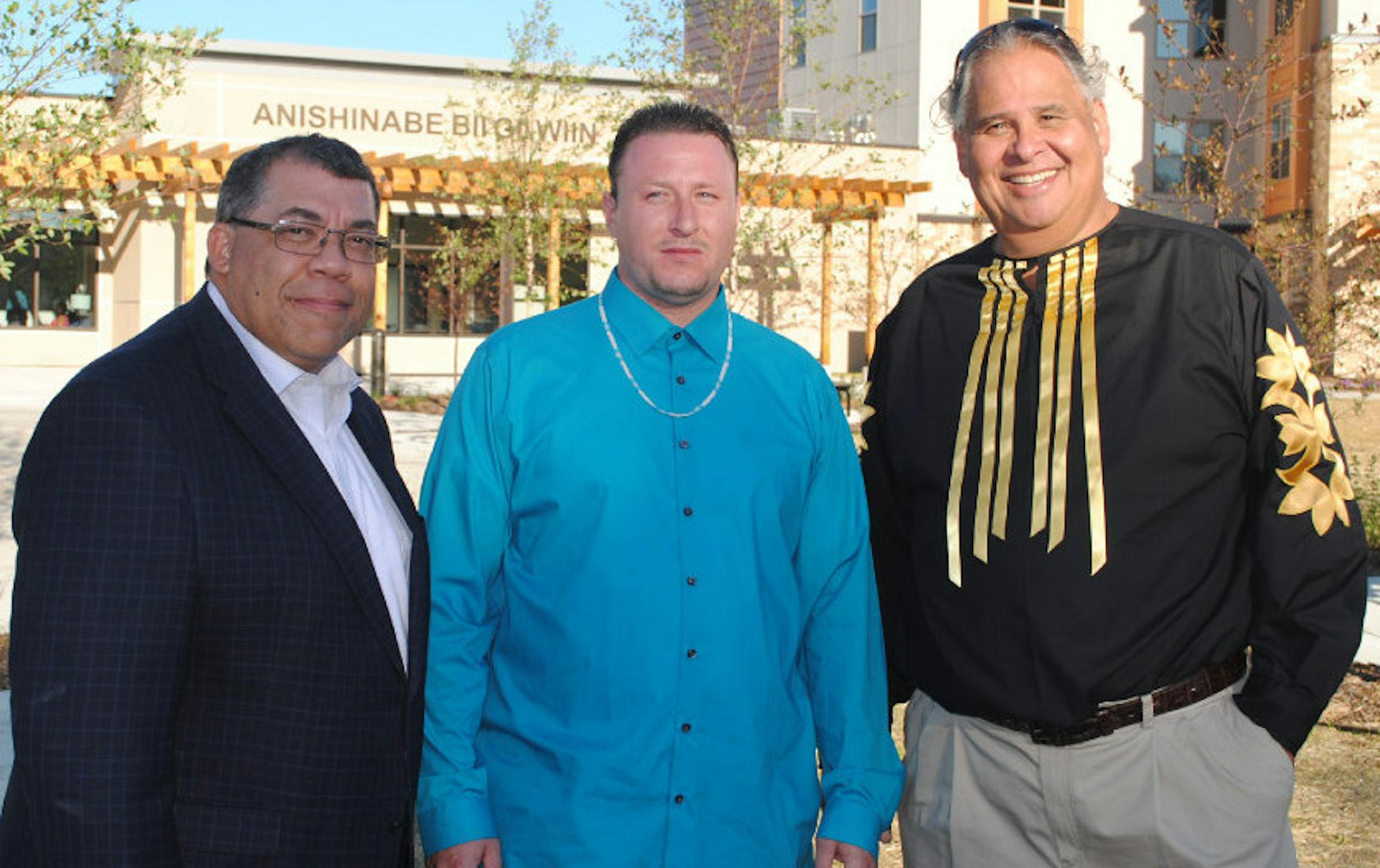 PPL CEO Paul Williams (left), resident Gabriel Corbesia, an apprentice carpenter, and CEO Michael Goze of the American Indian Community Development Corp (AICDC) posed in front of the Anishinabe Bii Gii Wiin apartments in 2016. The 32 studio apartments near E. Franklin Avenue and Bloomington Avenue, were added to Anishinabel Wakiagun, 45 suppotive-housing units developed in the 1990s by AICDC and PPL. Photo: Neal.St.Anthony@startribune.com