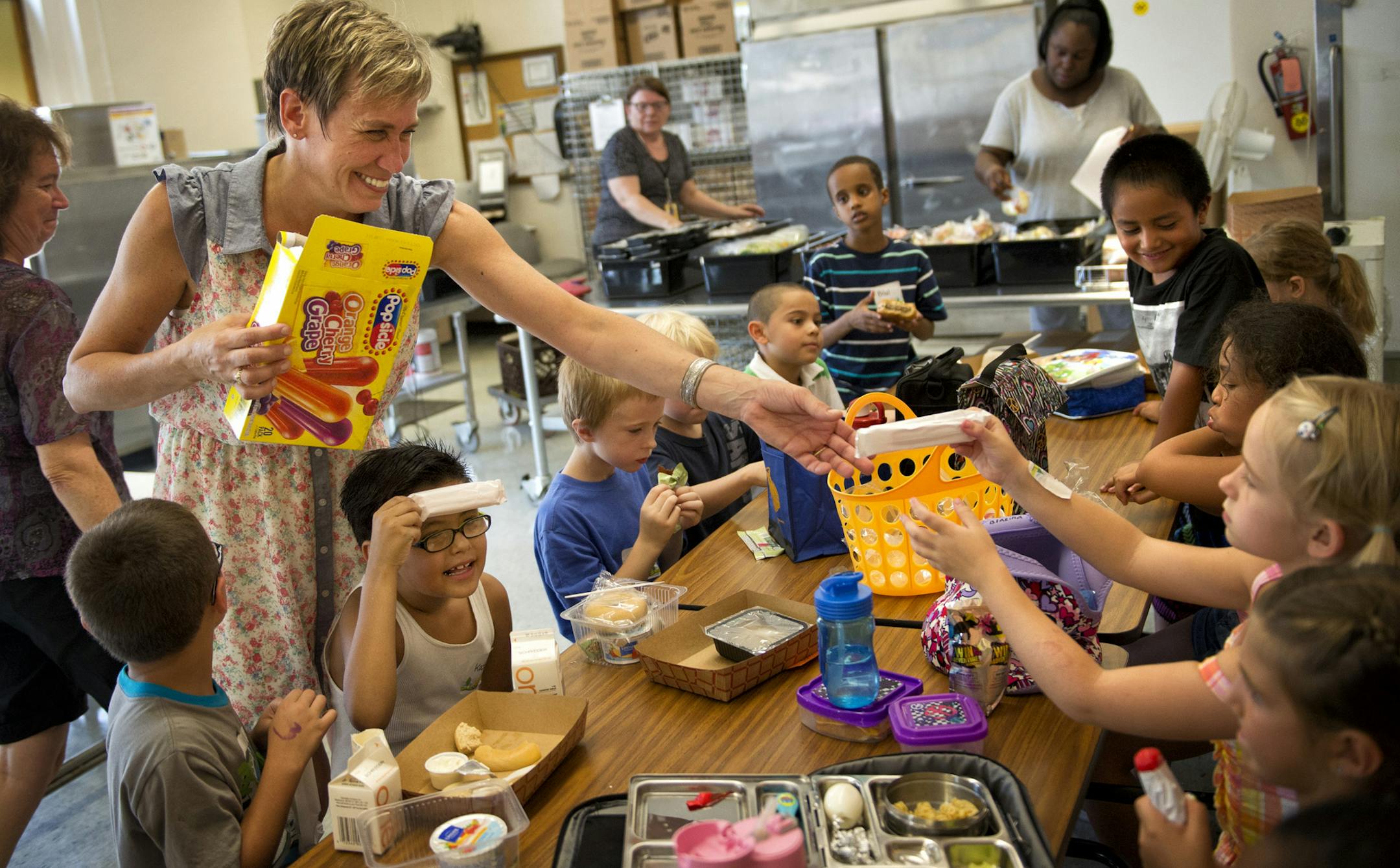 Aug. 26, 2013: Lisa Horn distributed Popsicles to students in the Hiawatha Elementary School cafeteria, where temperatures were in the mid-80s. The Minneapolis school is without air conditioning and struggled through the first day of classes with lots of bottled water and donated ice.